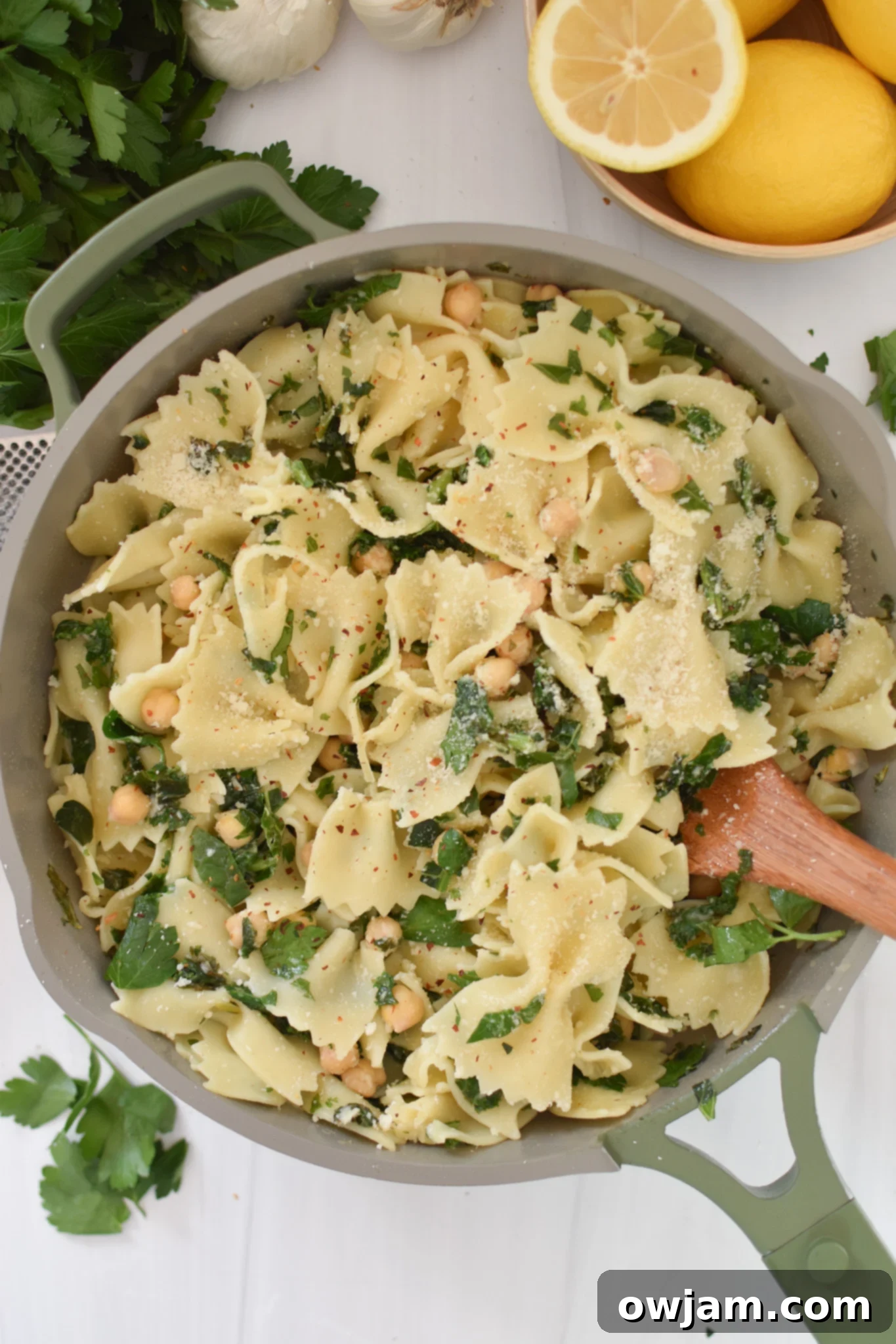 Cheesy Kale Pasta without the cheese and a spoon in the pasta. 