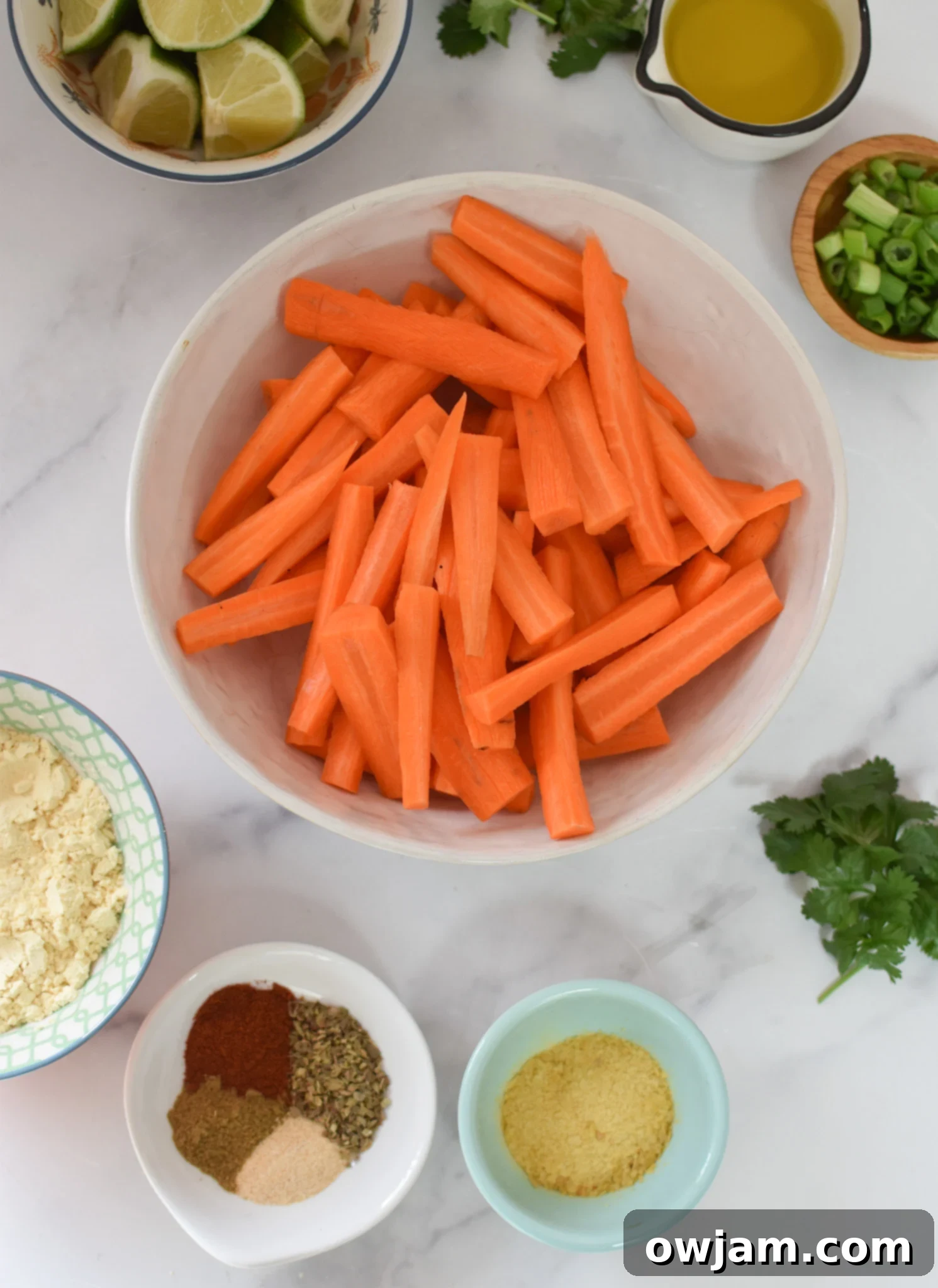 Roasted Carrot Fries 3 Close-up of Oven Baked Carrot Fries ingredients laid out on a cutting board.