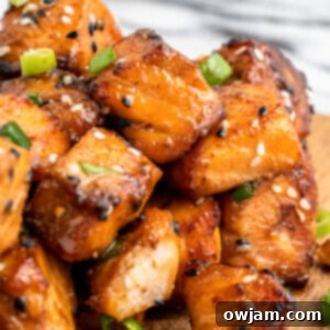 Crispy Teriyaki Air Fryer Salmon Bites 10 Air Fryer Salmon Bites on a cutting board.