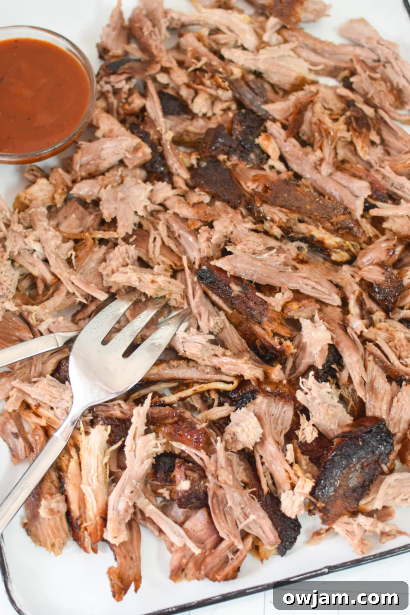 Effortless Oven Pulled Pork Perfection 6 Beautifully shredded pork Boston butt after roasting, resting on a cutting board, ready to be served.