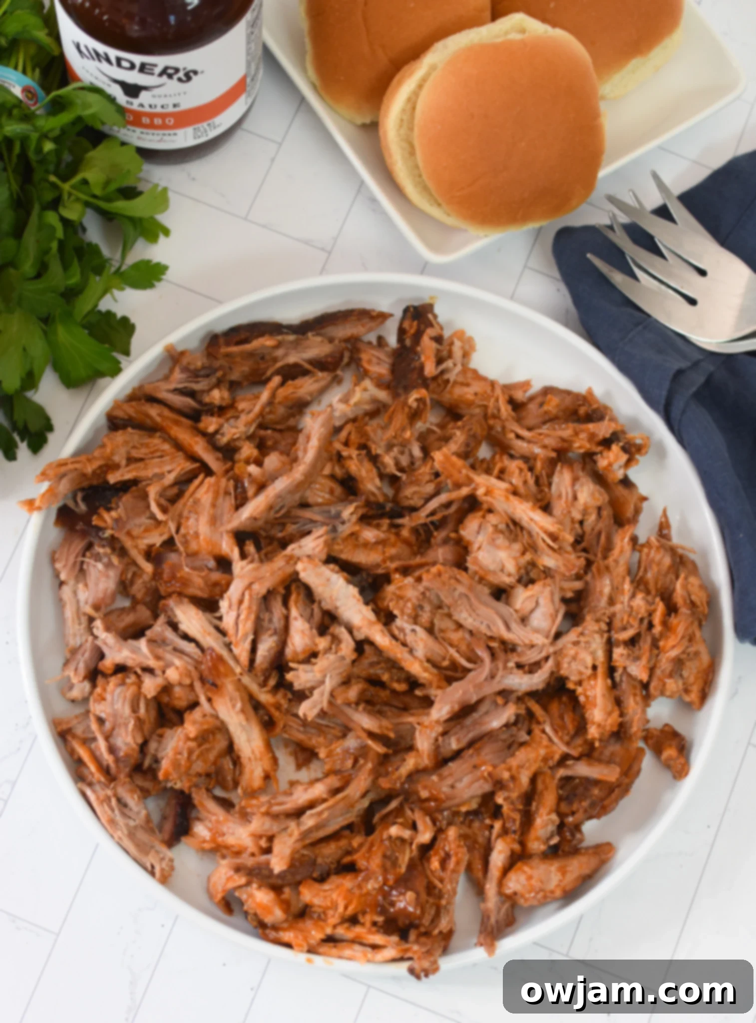Oven Roasted Boston Butt Pulled Pork Perfection 8 Cooked and shredded Boston butt plated on a white dish, ready to be enjoyed as a meal