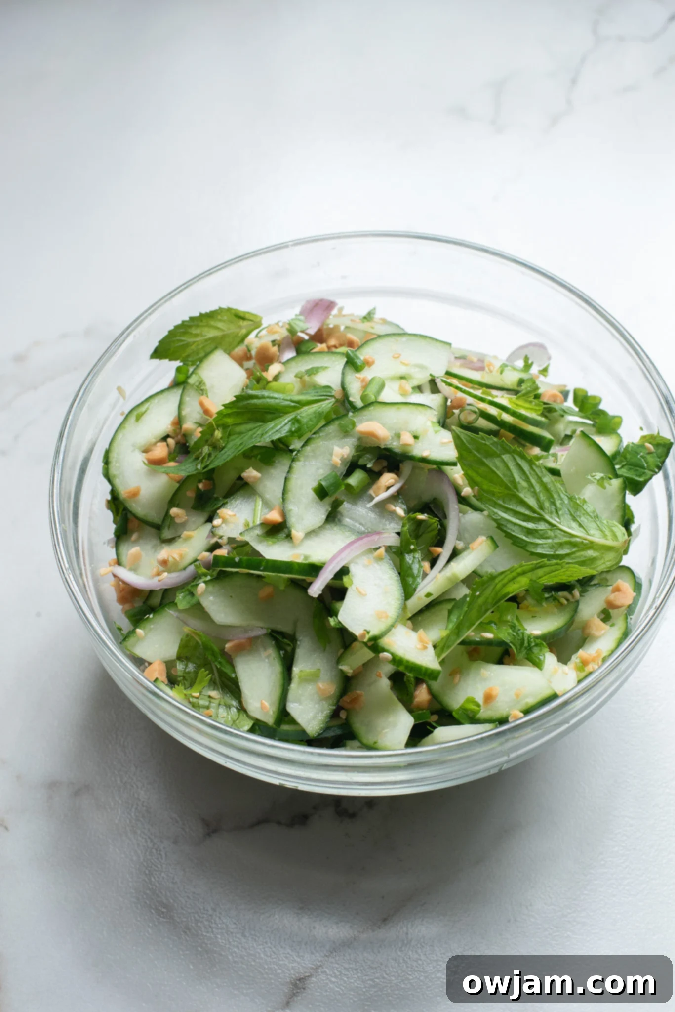Zesty Thai Cucumber Delight 7 Thai Cucumber Salad ingredients in a glass bowl.