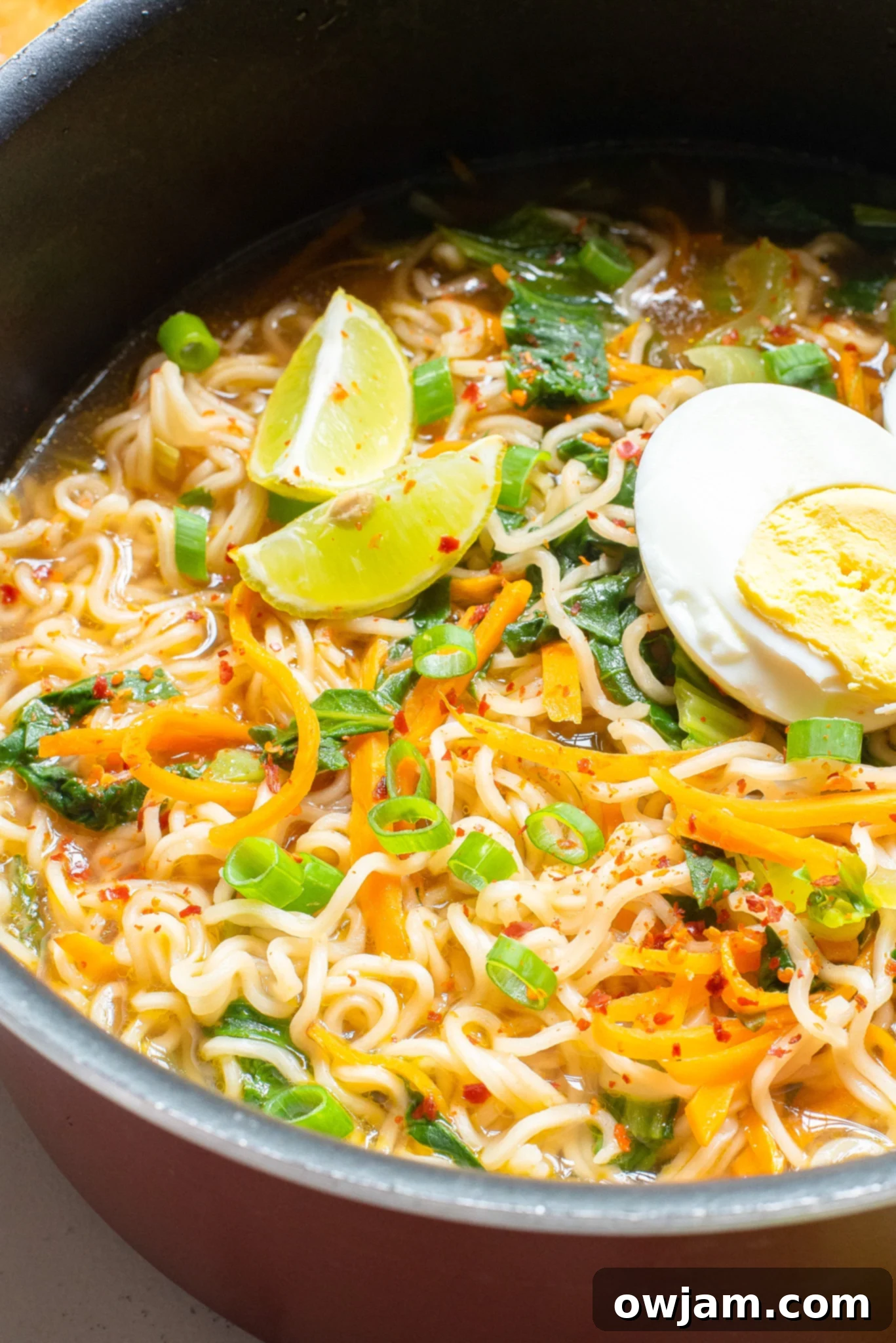 Easy Ramen Noodle Soup in a bowl with lime wedges on the side.