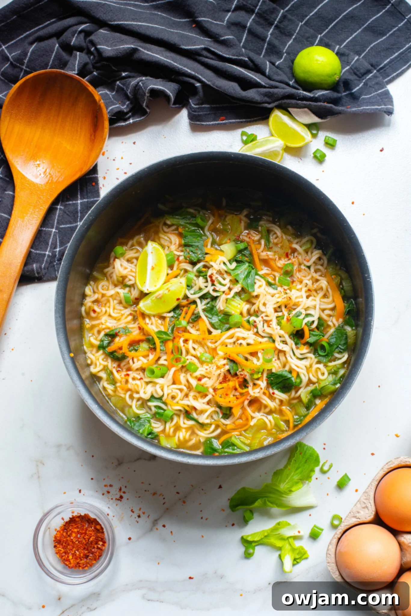Easy Ramen Noodle Soup being served with a wooden spoon.