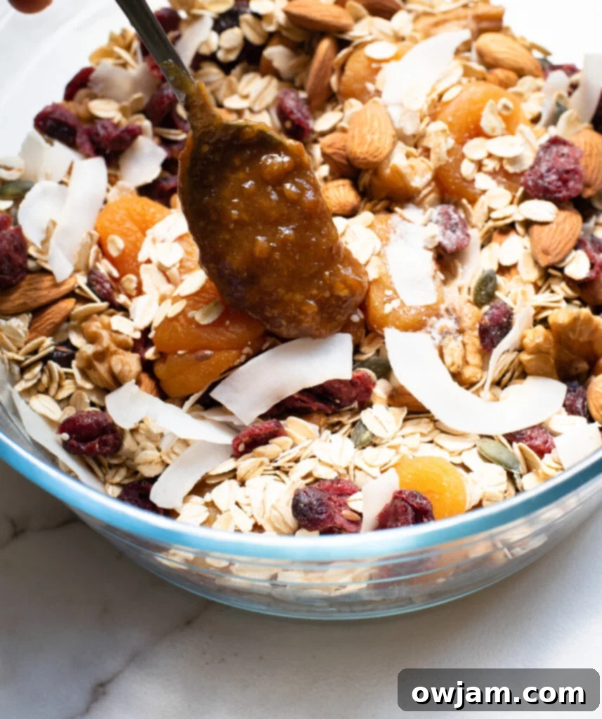 Effortless Date Granola Bars 7 Easy Date Granola Bars ingredients in a bowl with date paste being added.