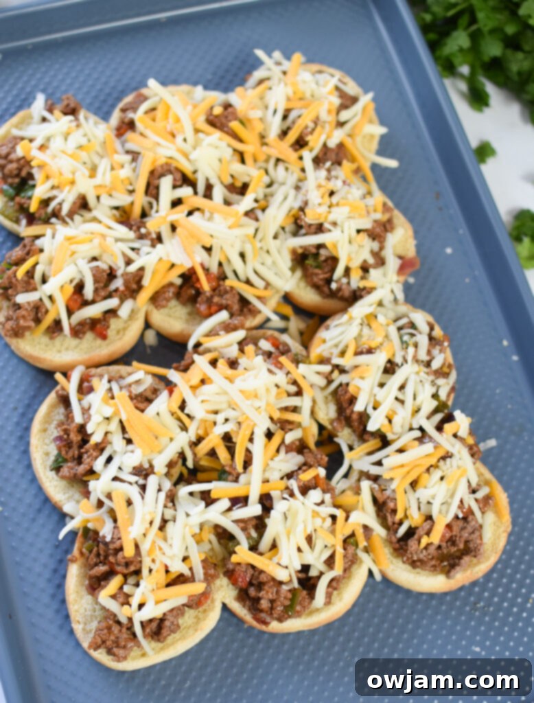 Taco Beef Sliders cheese on the beef on the buns.