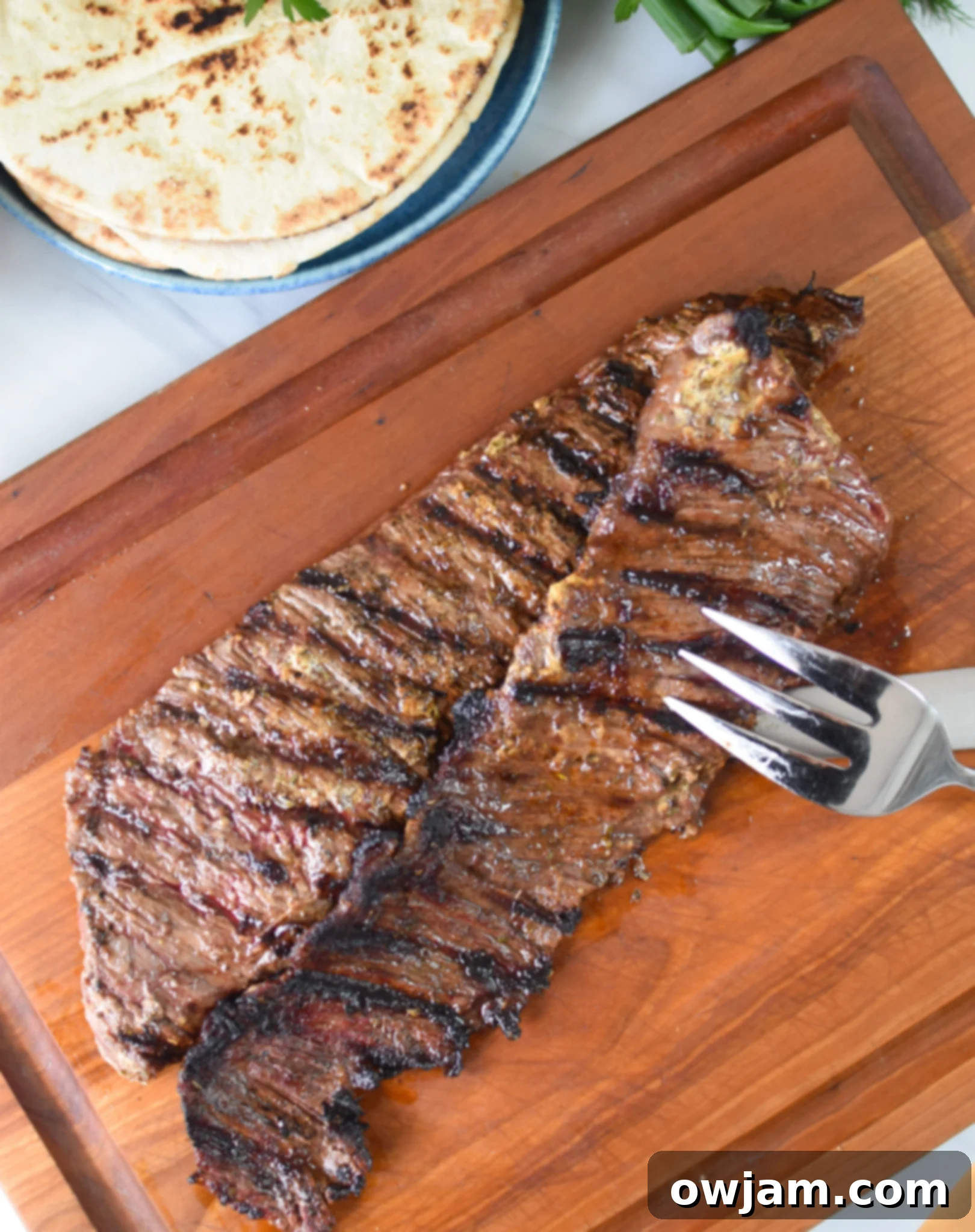 Easy Beef Gyros beef on a cutting board.