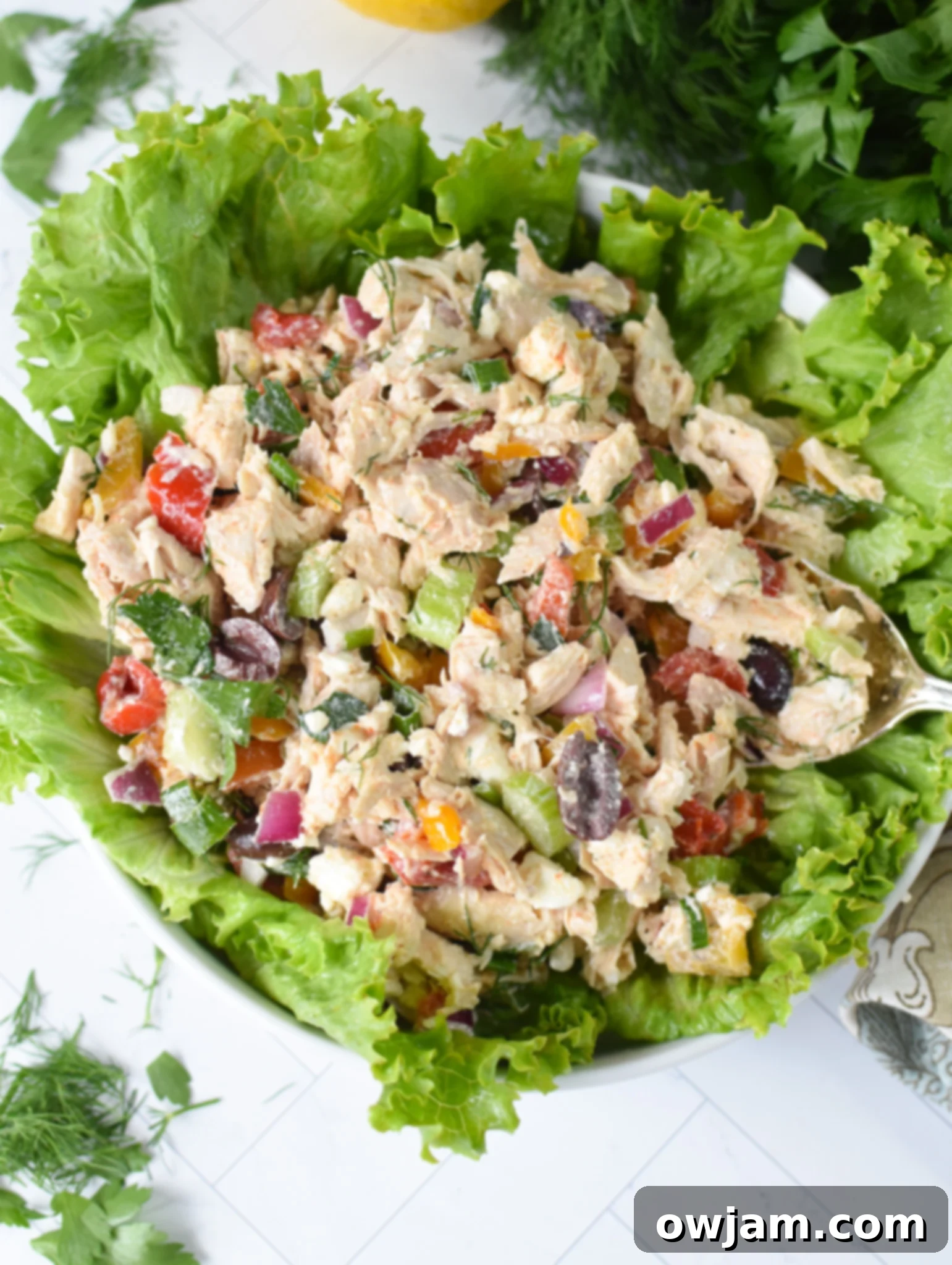 Healthy Mediterranean Chicken Salad served over a bed of crisp lettuce leaves.