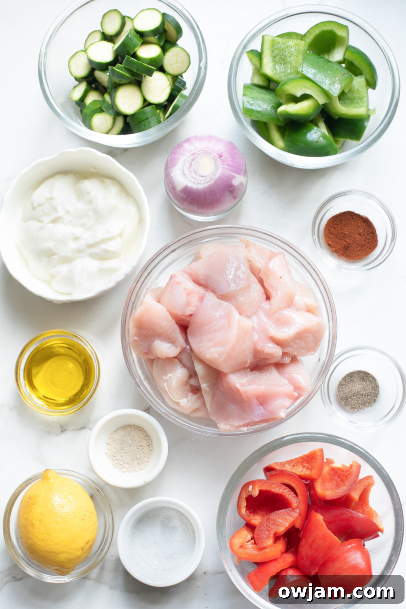 Zesty Greek Chicken Kabobs 3 Fresh ingredients for Greek Marinated Chicken Kabobs with Lemon laid out on a cutting board.