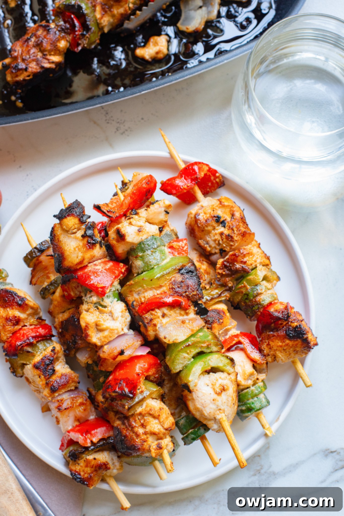 Zesty Greek Chicken Kabobs 5 Plated Greek Marinated Chicken Kabobs with Lemon, ready to serve.