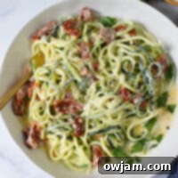 Creamy Zucchini Noodle Alfredo A Guilt-Free Treat 12 Alfredo Zoodles Recipe in a white bowl.