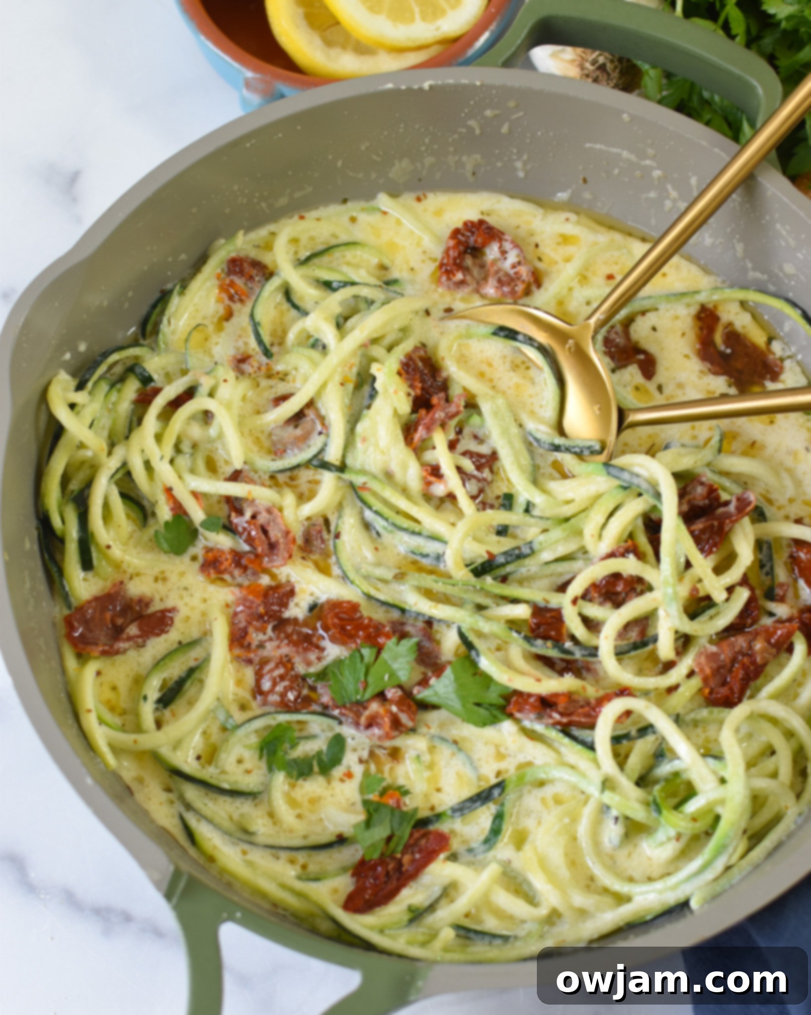 Alfredo Zoodles Recipe with fork and spoon. 