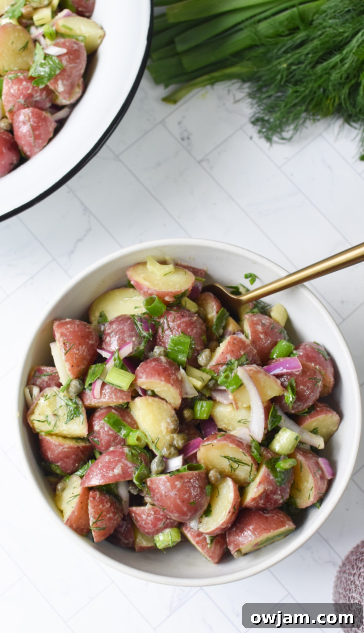Close-up of No Mayo Potato Salad with a gold spoon, ready to be served.