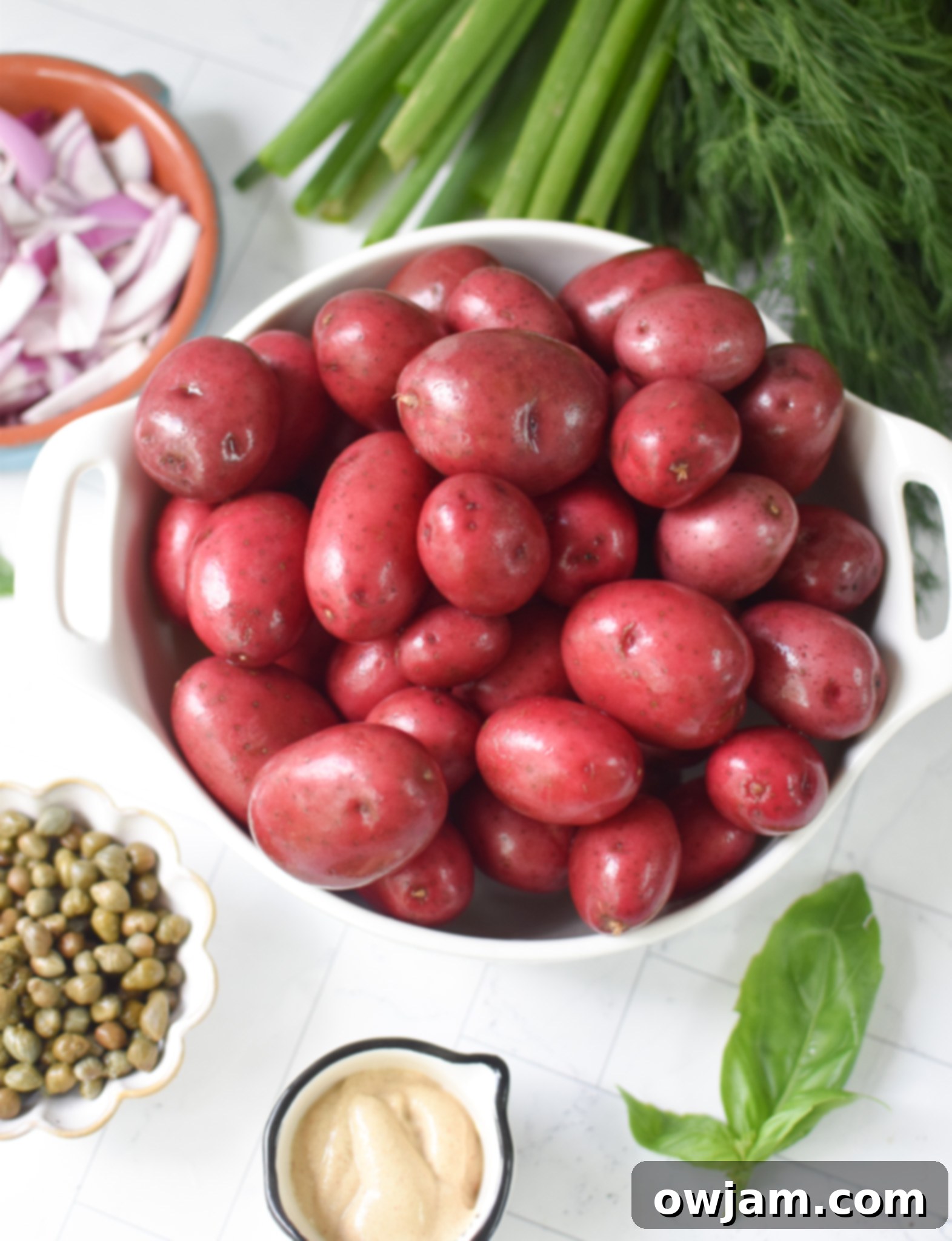 Sliced red potatoes in a pot, ready for boiling for No Mayo Potato Salad.