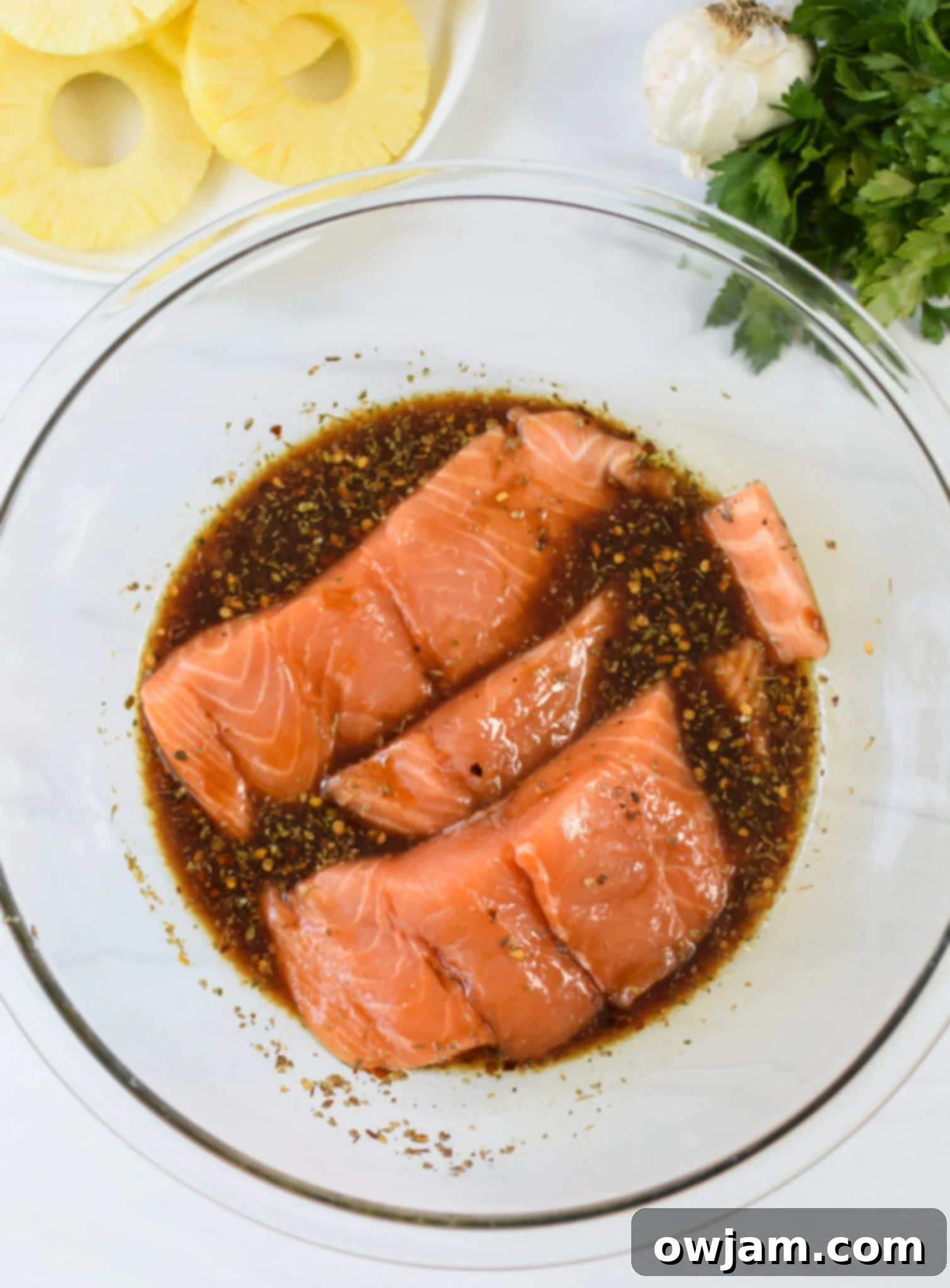 Aloha Grilled Salmon 7 Hawaiian Grilled Salmon marinade in a bowl with salmon.