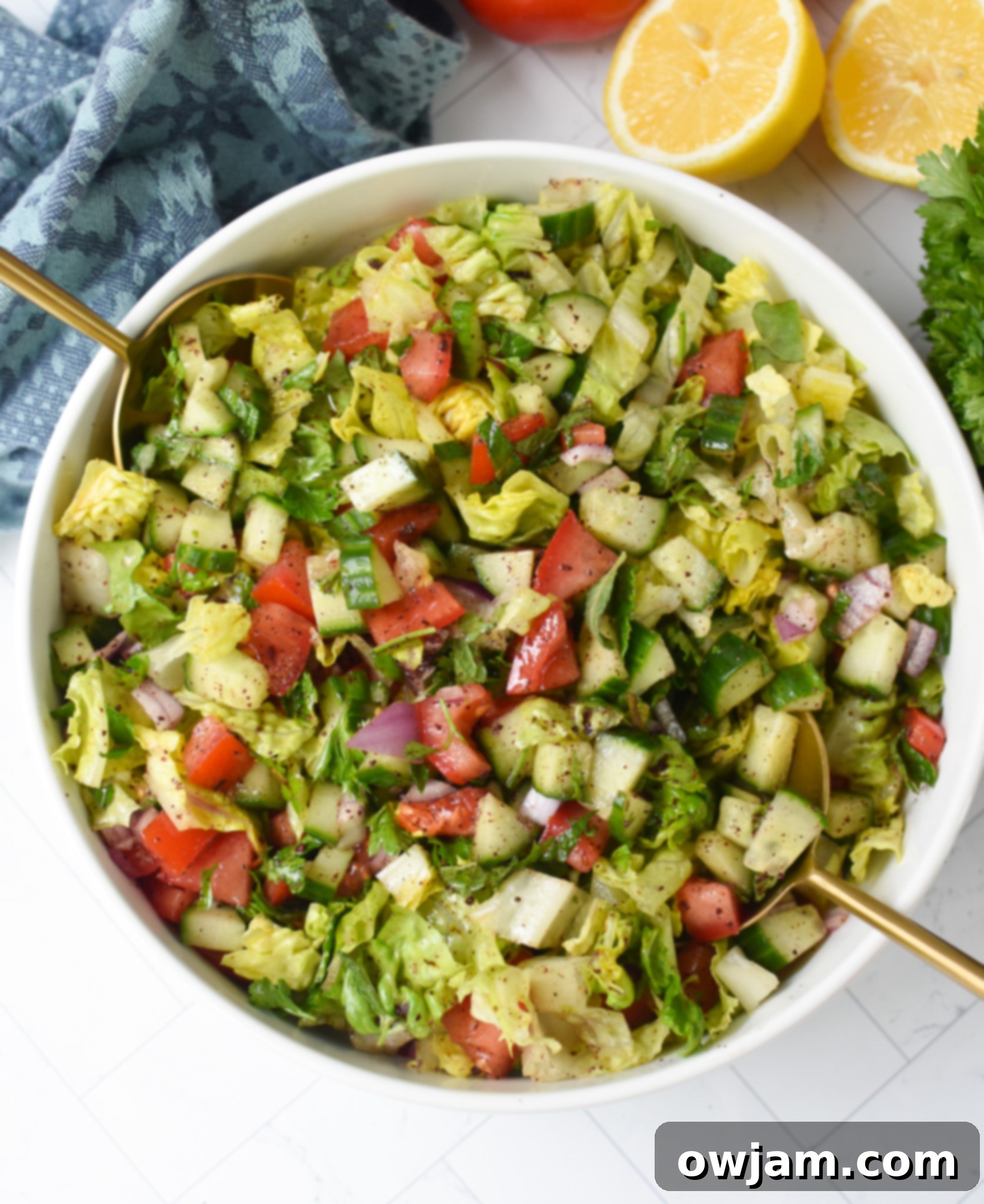 Simple Arabic Salad 2 Easy Arabic Salad with gold serving spoons, showcasing its fresh, chopped ingredients and inviting colors.