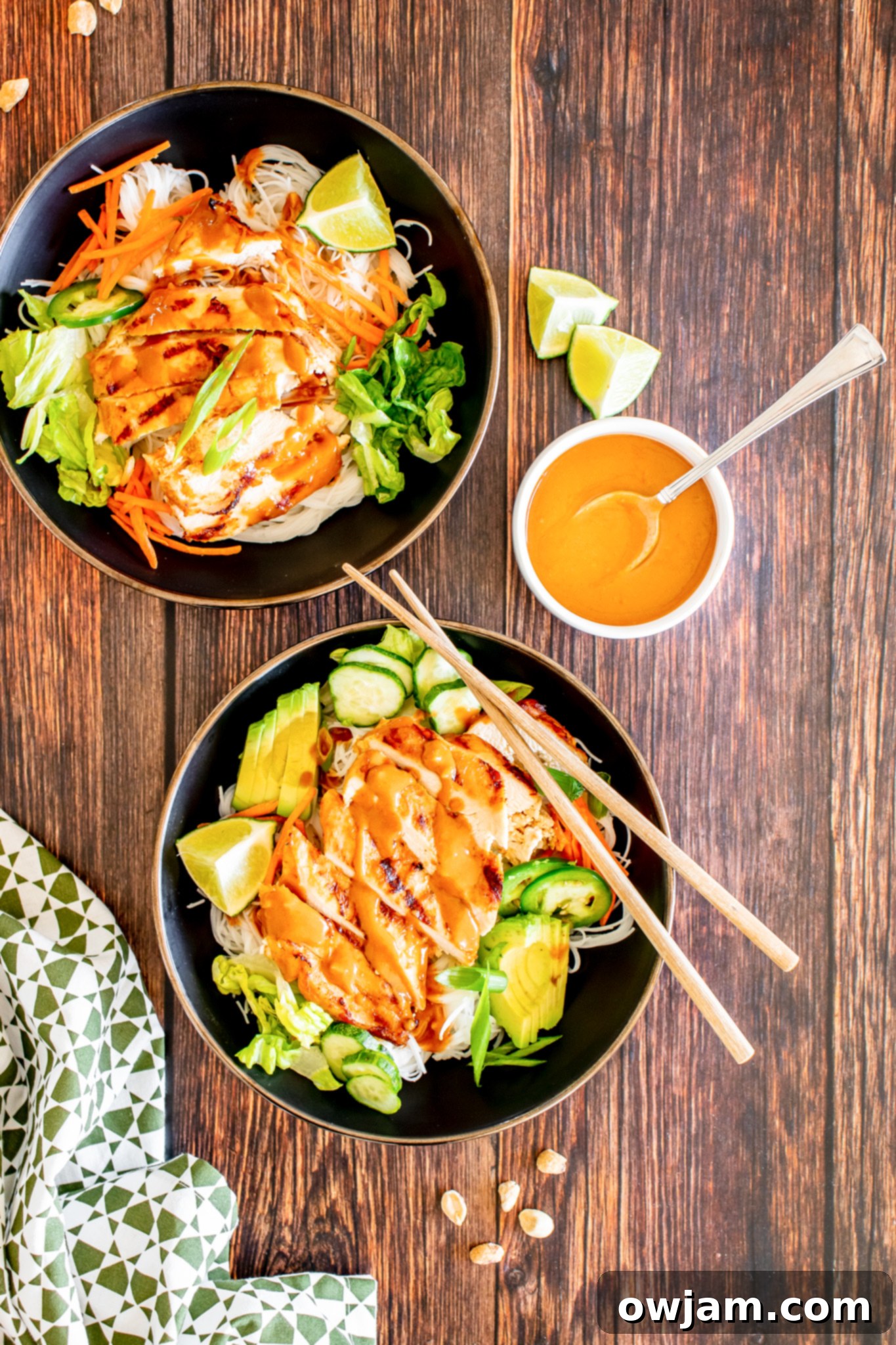 Thai Chicken Noodle Salad drizzled with sauce, ready to serve.