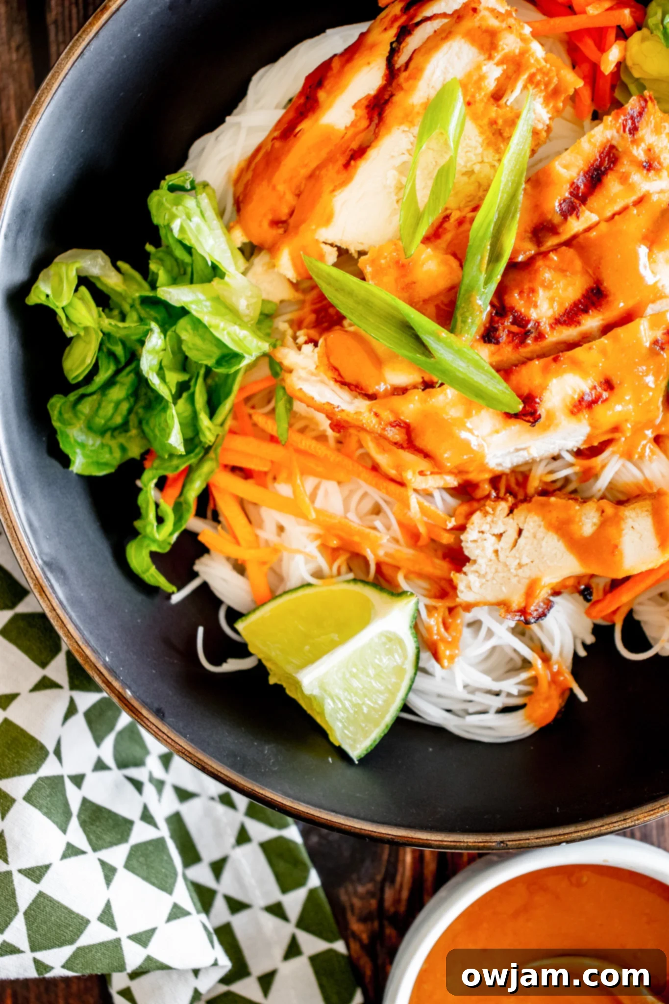 Thai Chicken Noodle Salad in a black bowl. A close-up of a delicious and healthy chicken noodle salad.