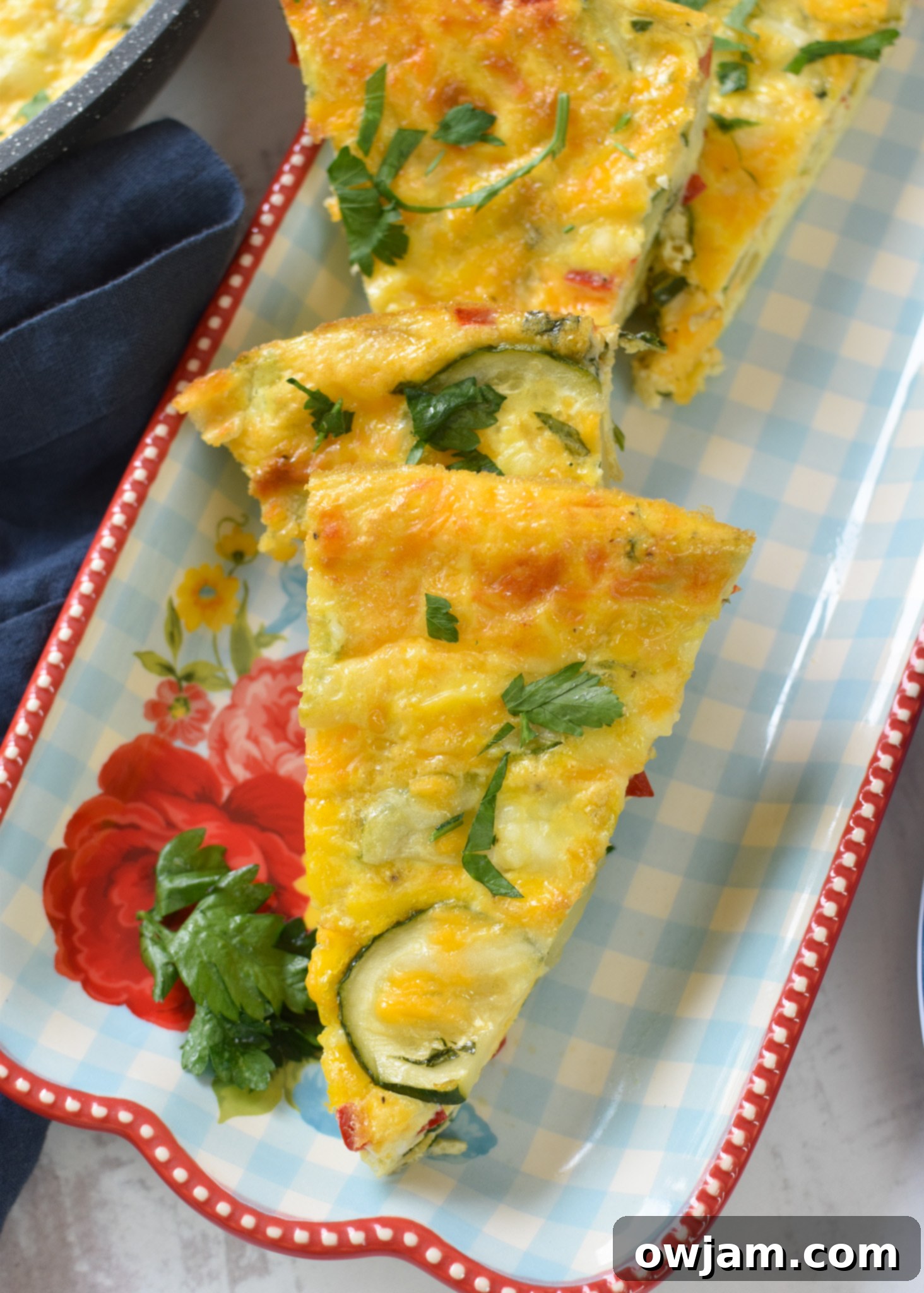 Savory Zucchini Frittata 12 A slice of Zucchini Frittata Recipe on a white plate, ready to be eaten.
