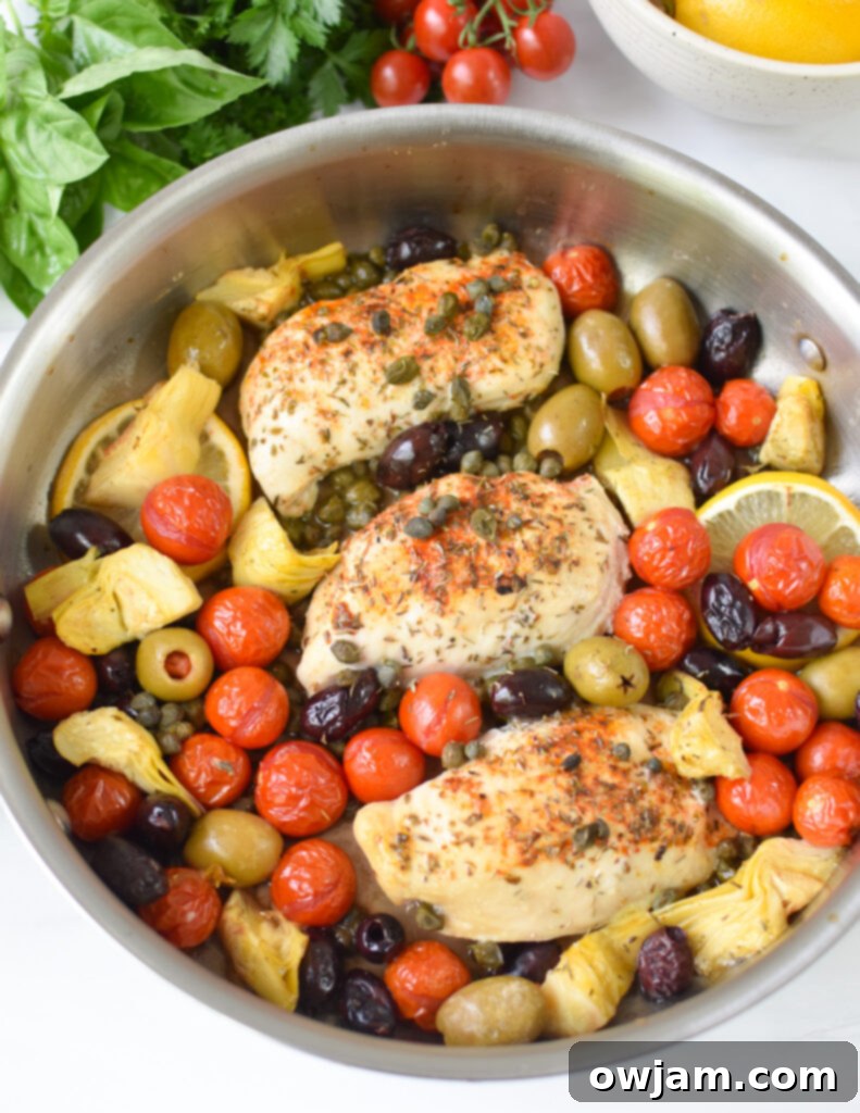 Easy Mediterranean Chicken Skillet 6 Close-up of seared Mediterranean chicken breasts in a hot skillet, before adding vegetables.