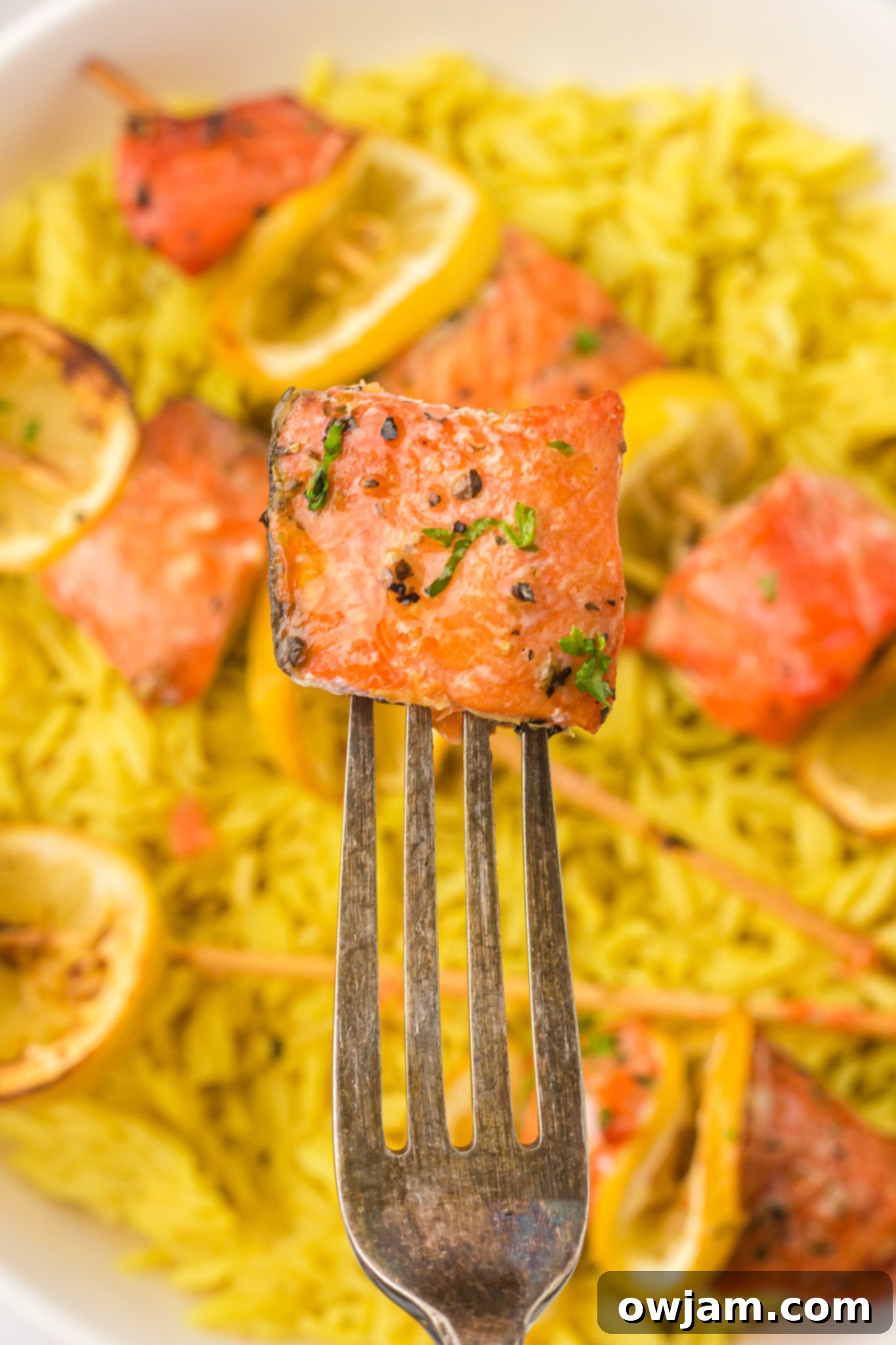 Zesty Lemon Salmon Skewers 11 Close-up of a cooked Easy Lemon Salmon Kabob on a fork, highlighting its flaky texture.