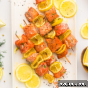 Zesty Lemon Salmon Skewers 13 Easy Lemon Salmon Kabobs on a white plate.