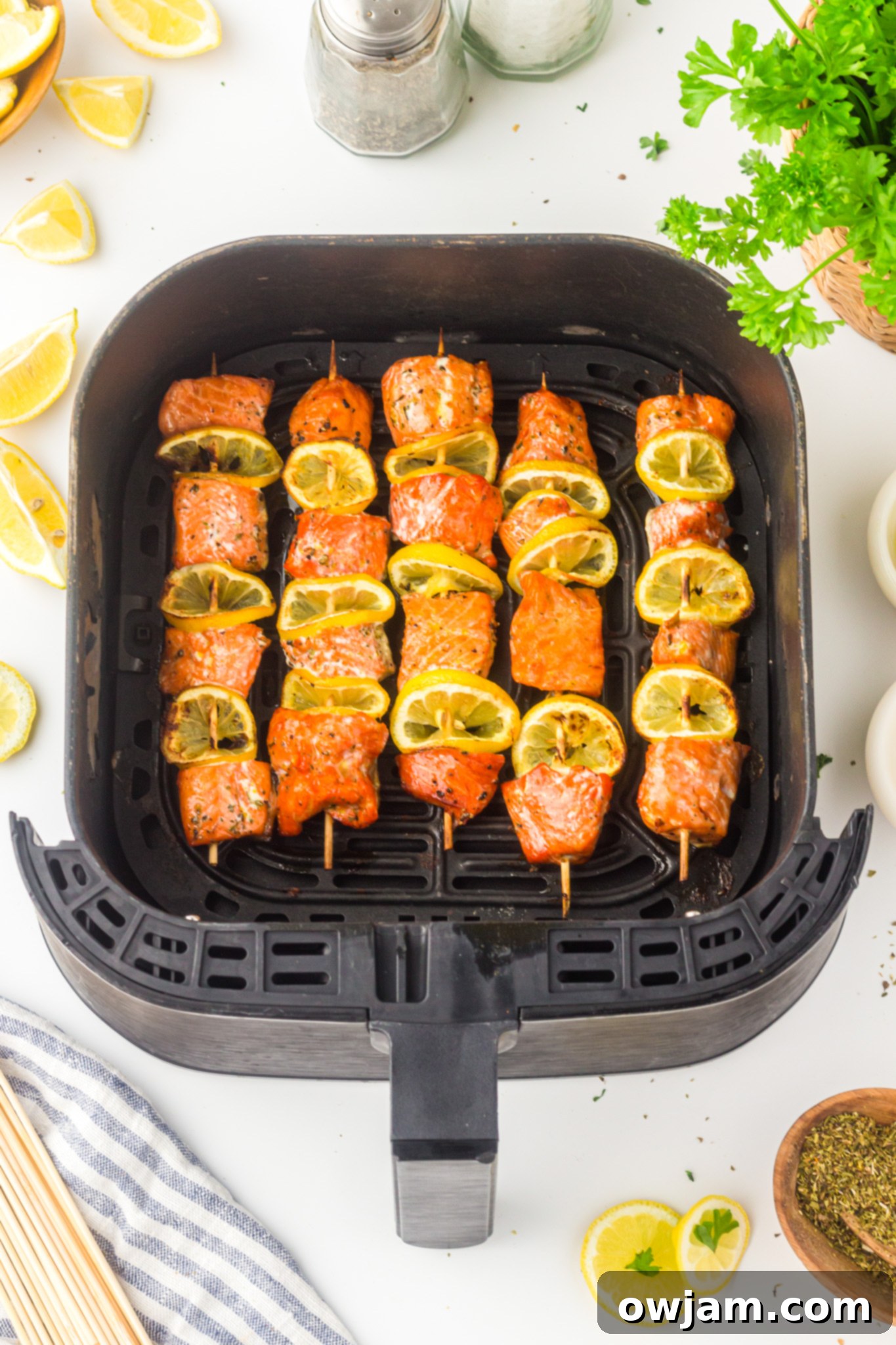 Zesty Lemon Salmon Skewers 9 Easy Lemon Salmon Kabobs cooking in an air fryer basket, showing a crispy texture.