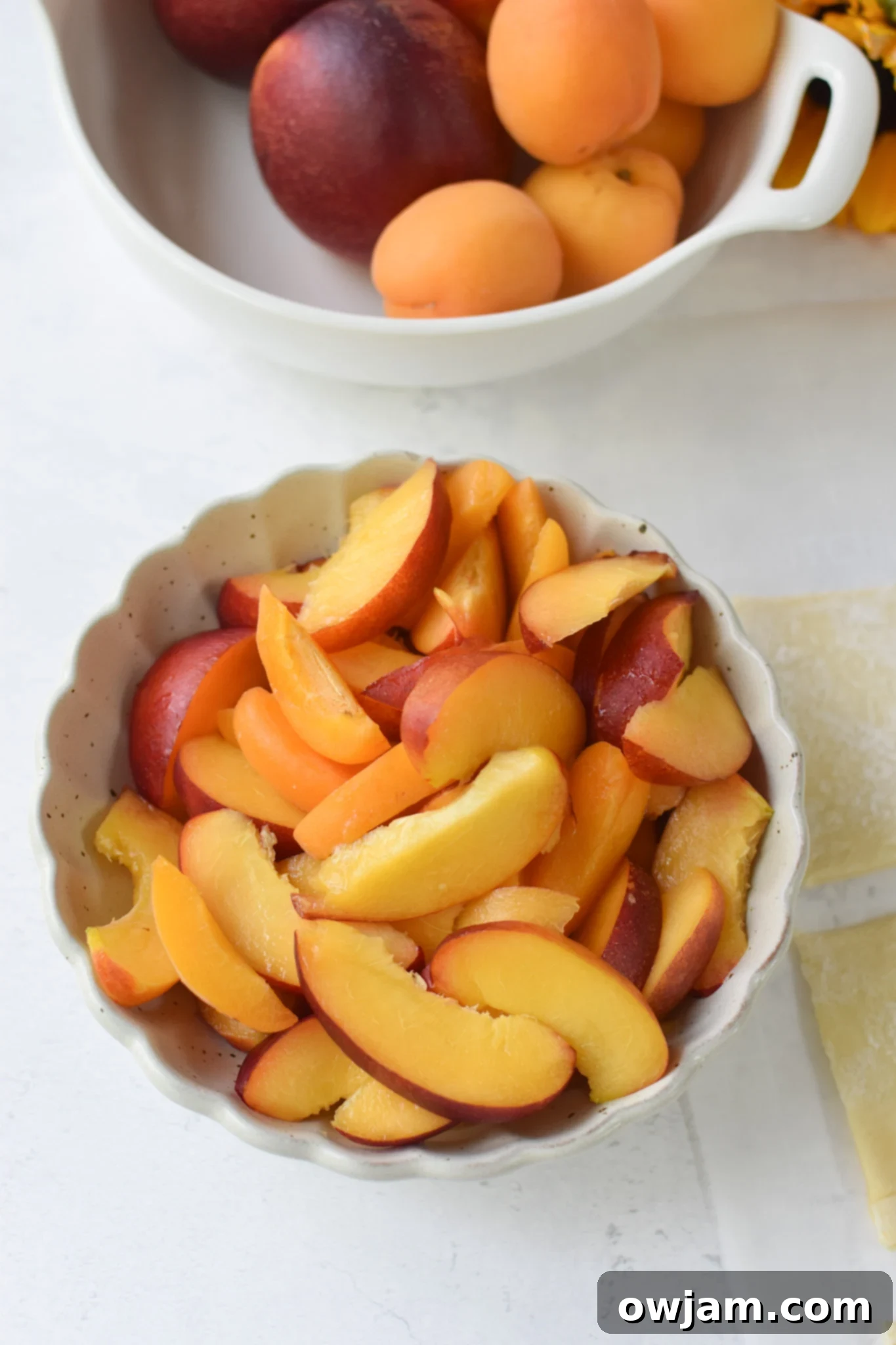 Easy Peach Tart sliced nectarines in a bowl. 