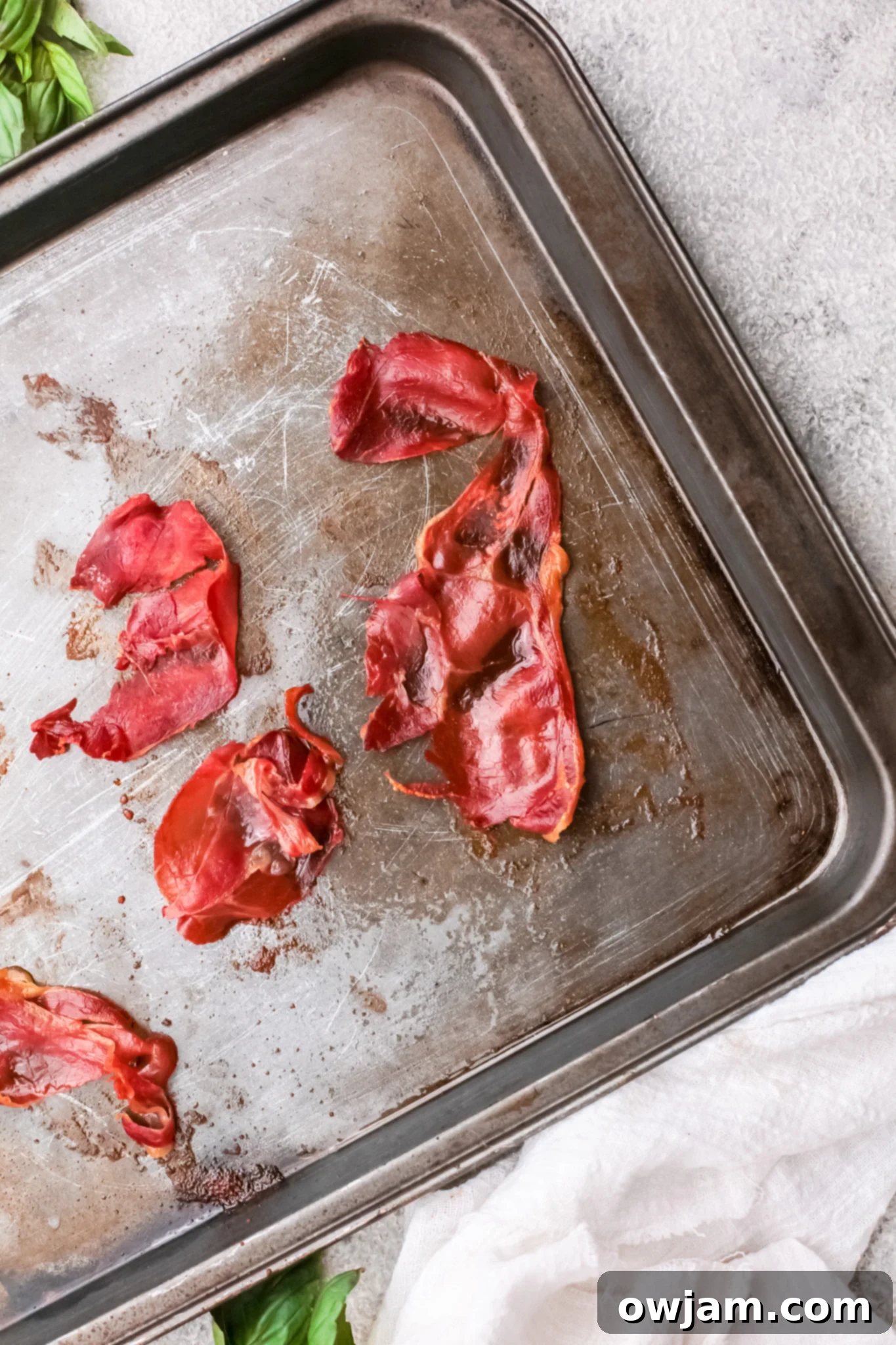 Crispy prosciutto on a baking tray after being baked for Prosciutto Pasta.