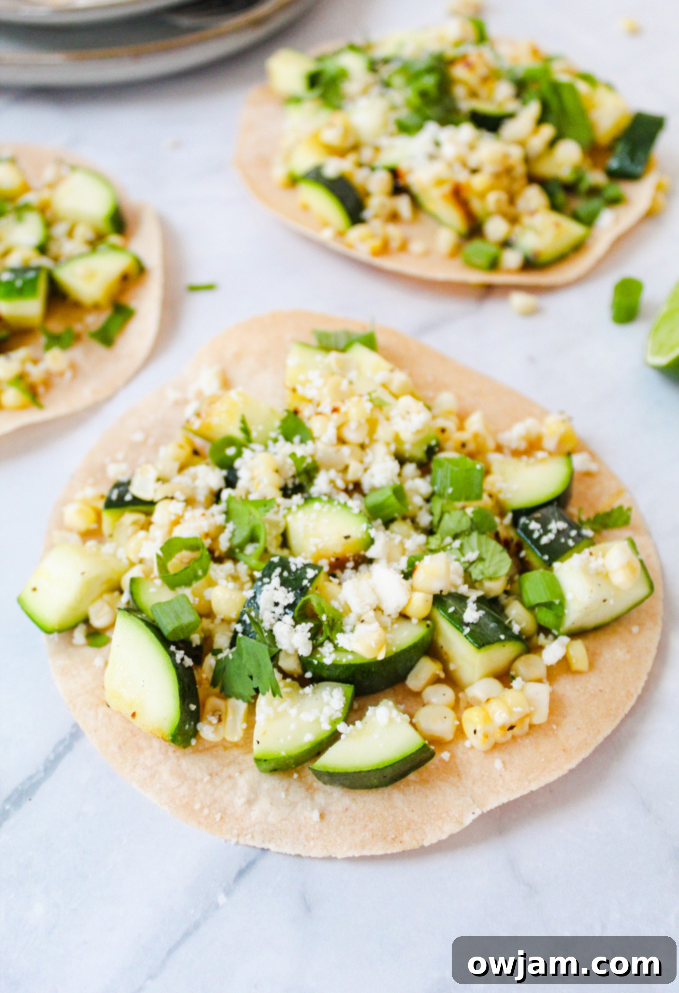 Zesty Zucchini Tacos 2 Easy Zucchini Tacos on a marble background, showcasing fresh ingredients and vibrant colors