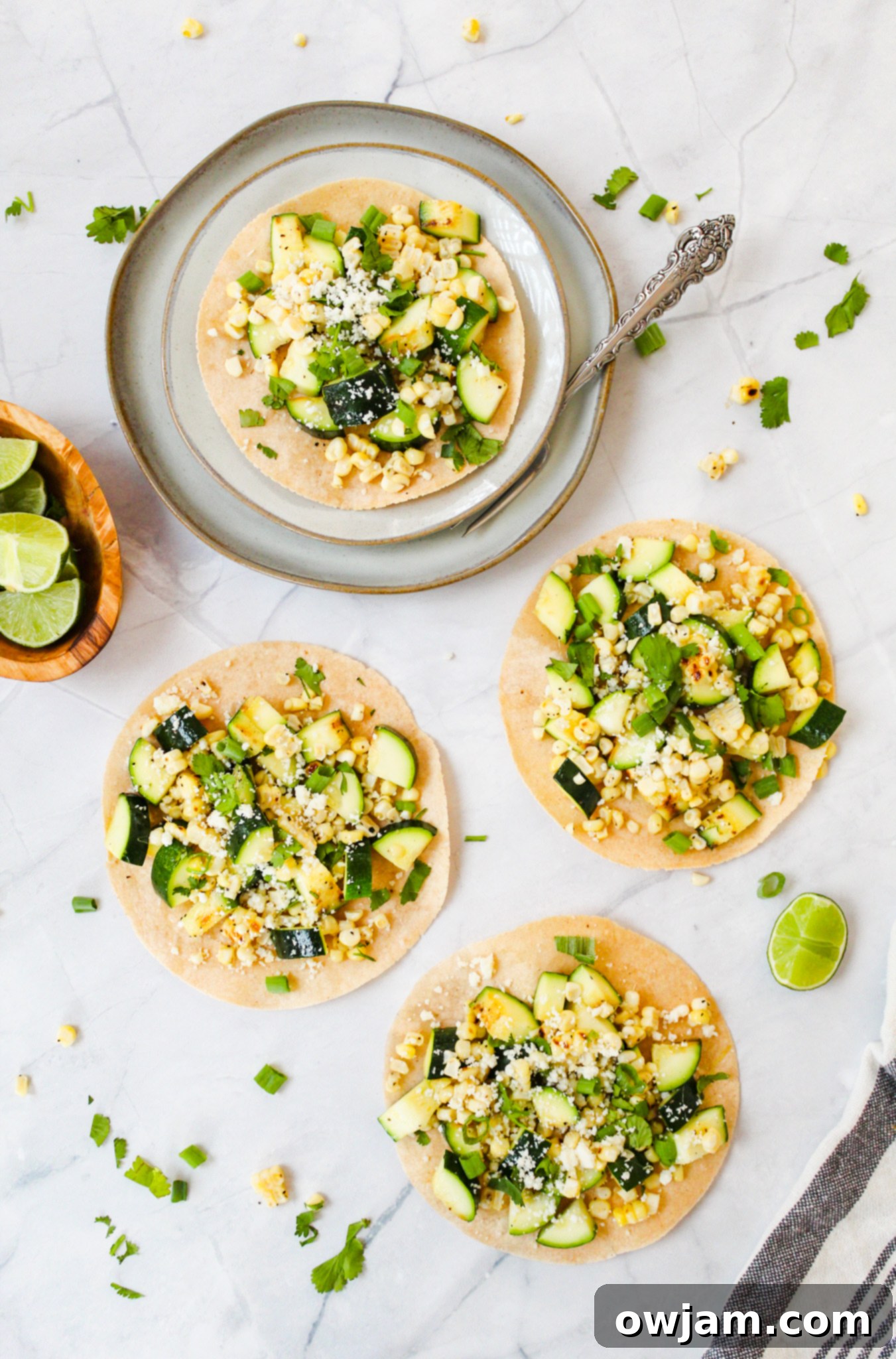 Zesty Zucchini Tacos 4 Easy Zucchini Tacos on a plate with a fork, ready to be enjoyed.