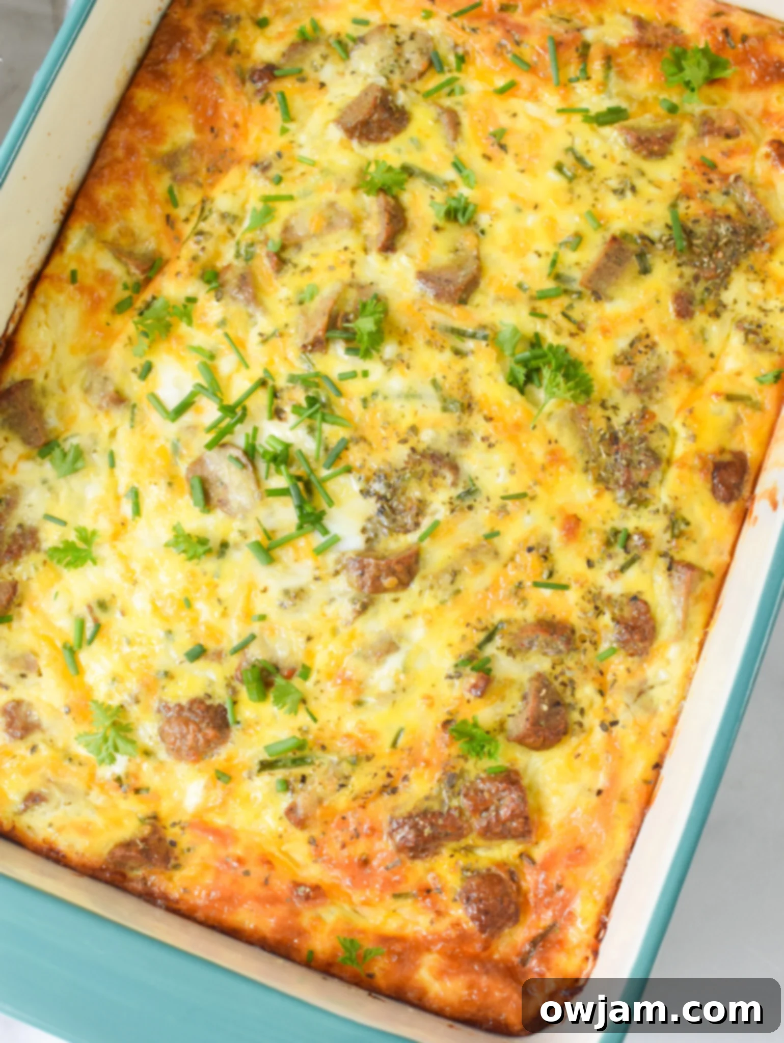 Baked Cheese and Sausage Eggs casserole in a dish, freshly out of the oven.