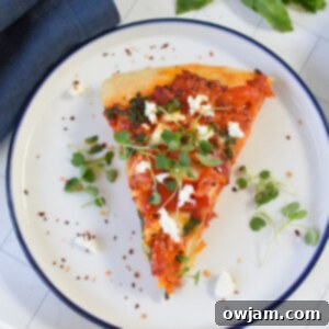 Rustic Cast Iron Mediterranean Pizza 10 Cast Iron Mediterranean Pizza on a white plate.