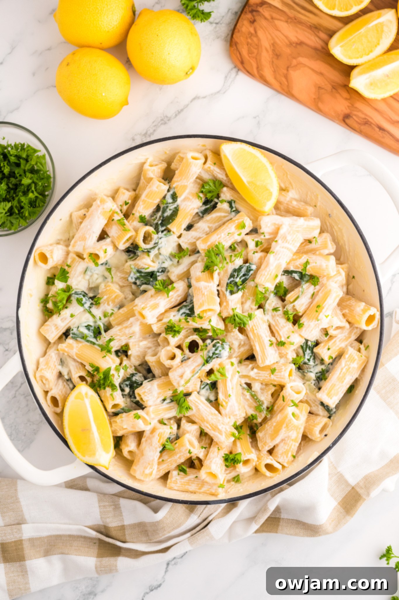 Zesty Lemon Ricotta Pasta 9 Lemon Ricotta Pasta ingredients mixed in a pot, showcasing the creamy sauce, pasta, and vibrant spinach.