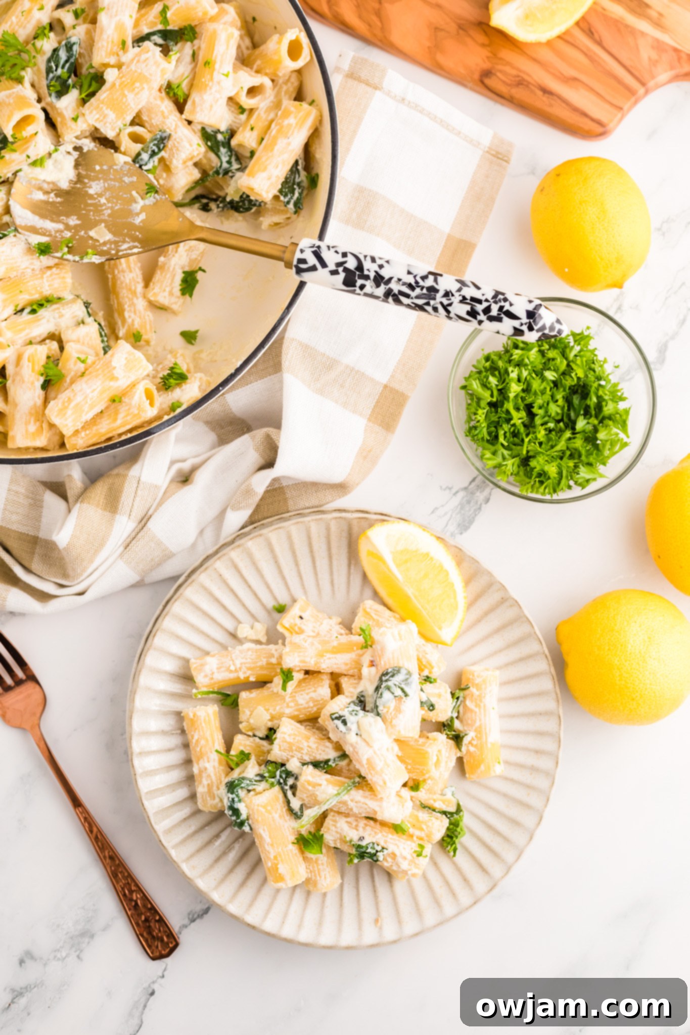 Zesty Lemon Ricotta Pasta 10 A serving of Lemon Ricotta Pasta on a white plate, highlighting the creamy sauce, pasta, and fresh greens.