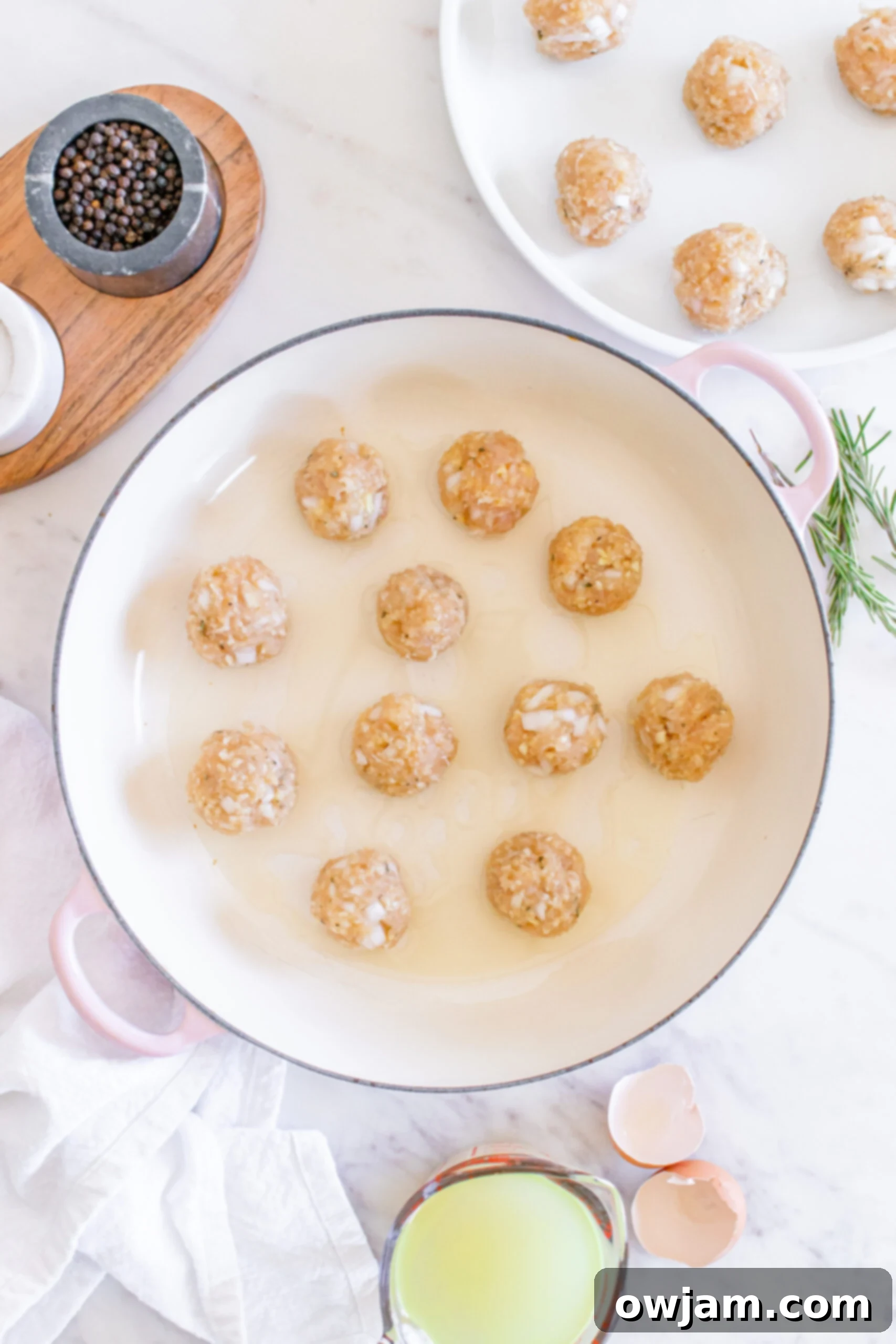 Sweet & Savory Maple Dijon Turkey Meatballs 9 Maple Dijon Turkey Meatballs browning in a skillet on the stove.