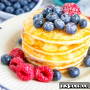 Cloud-Soft Buttermilk Pancakes 11 Homemade Buttermilk Pancakes on a white plate.