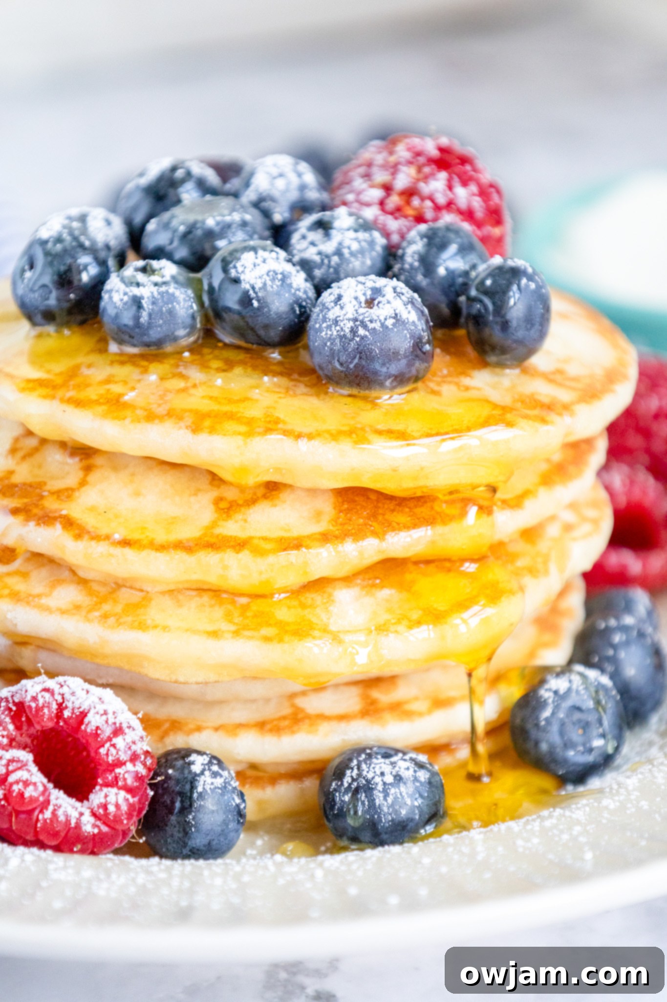 Cloud-Soft Buttermilk Pancakes 8 Homemade buttermilk pancake drizzled with maple syrup, garnished with fresh berries.