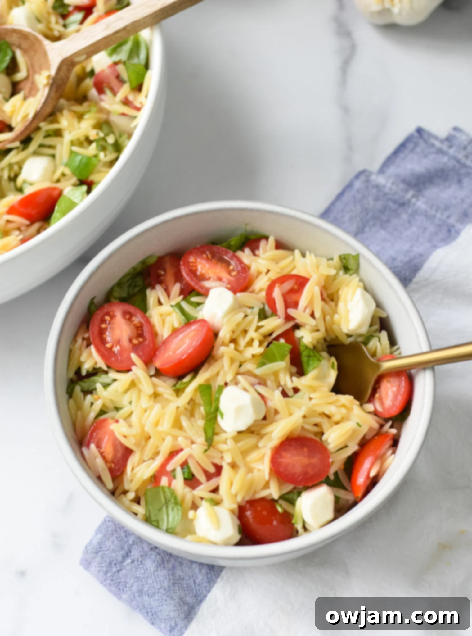 Caprese Orzo Pasta Salad with fork. 