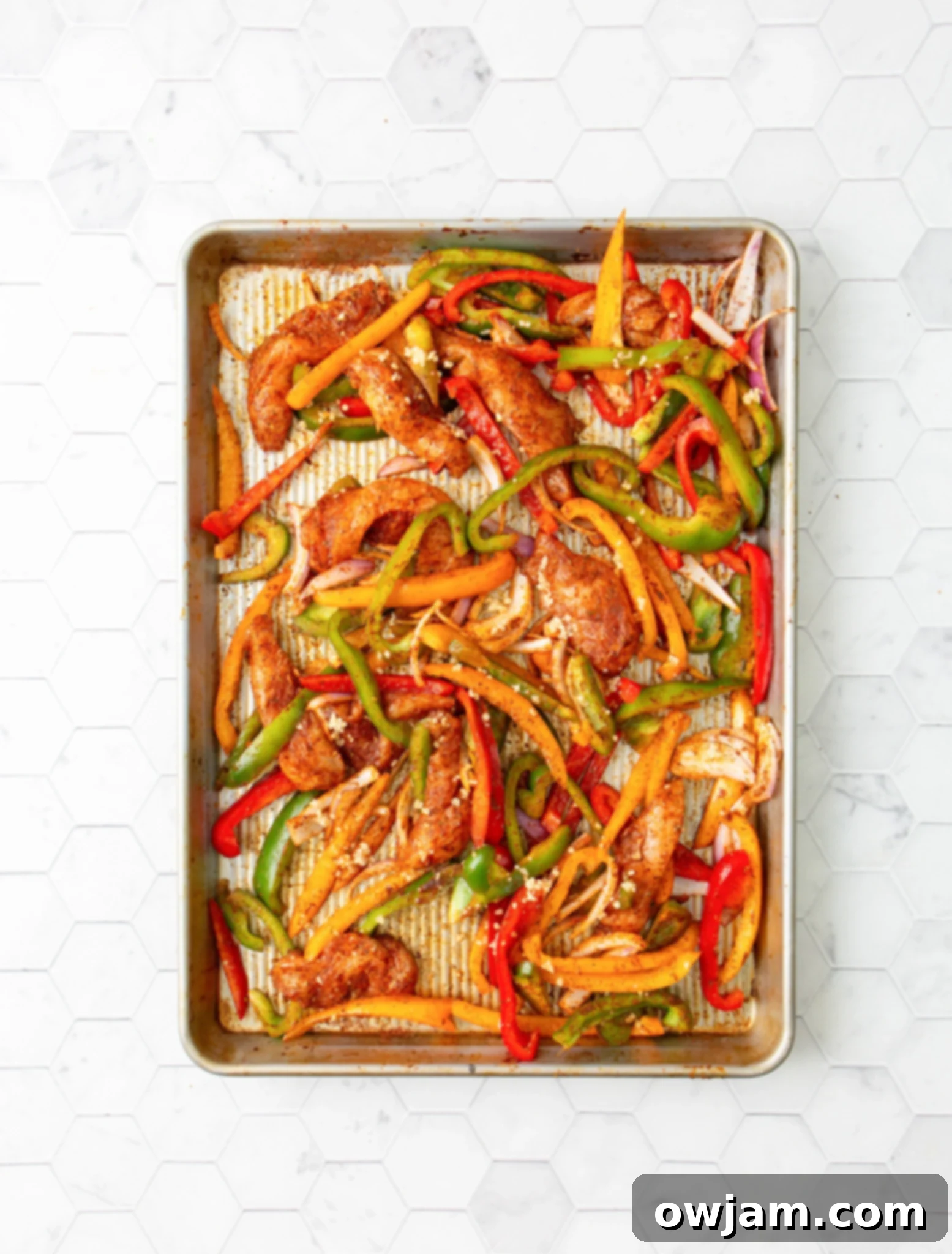 One-Pan Chicken Fajita Feast 6 Sheet Pan Chicken Fajitas seasoning on chicken and vegetables.