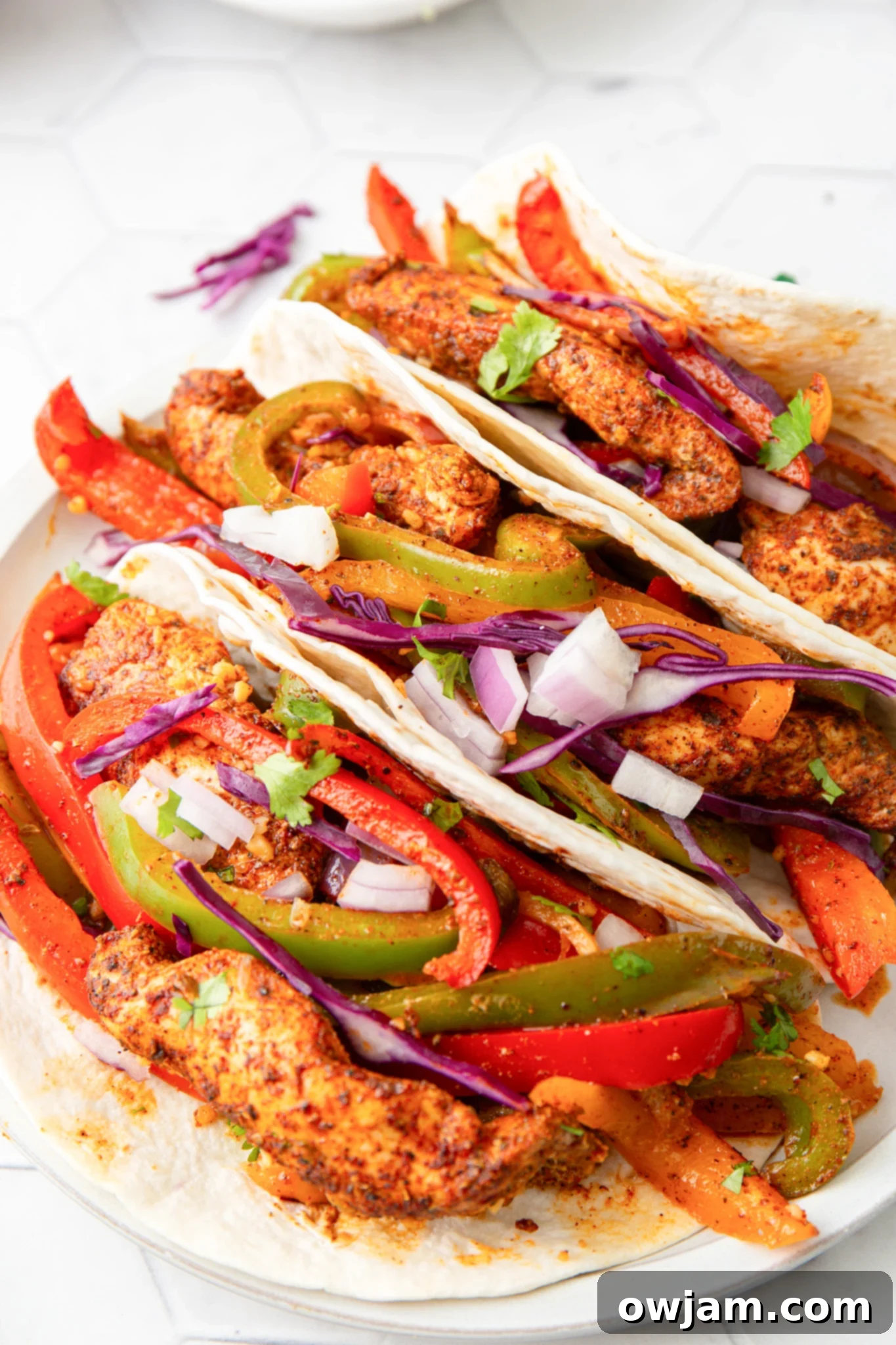 One-Pan Chicken Fajita Feast 9 Sheet Pan Chicken Fajitas in tortillas.