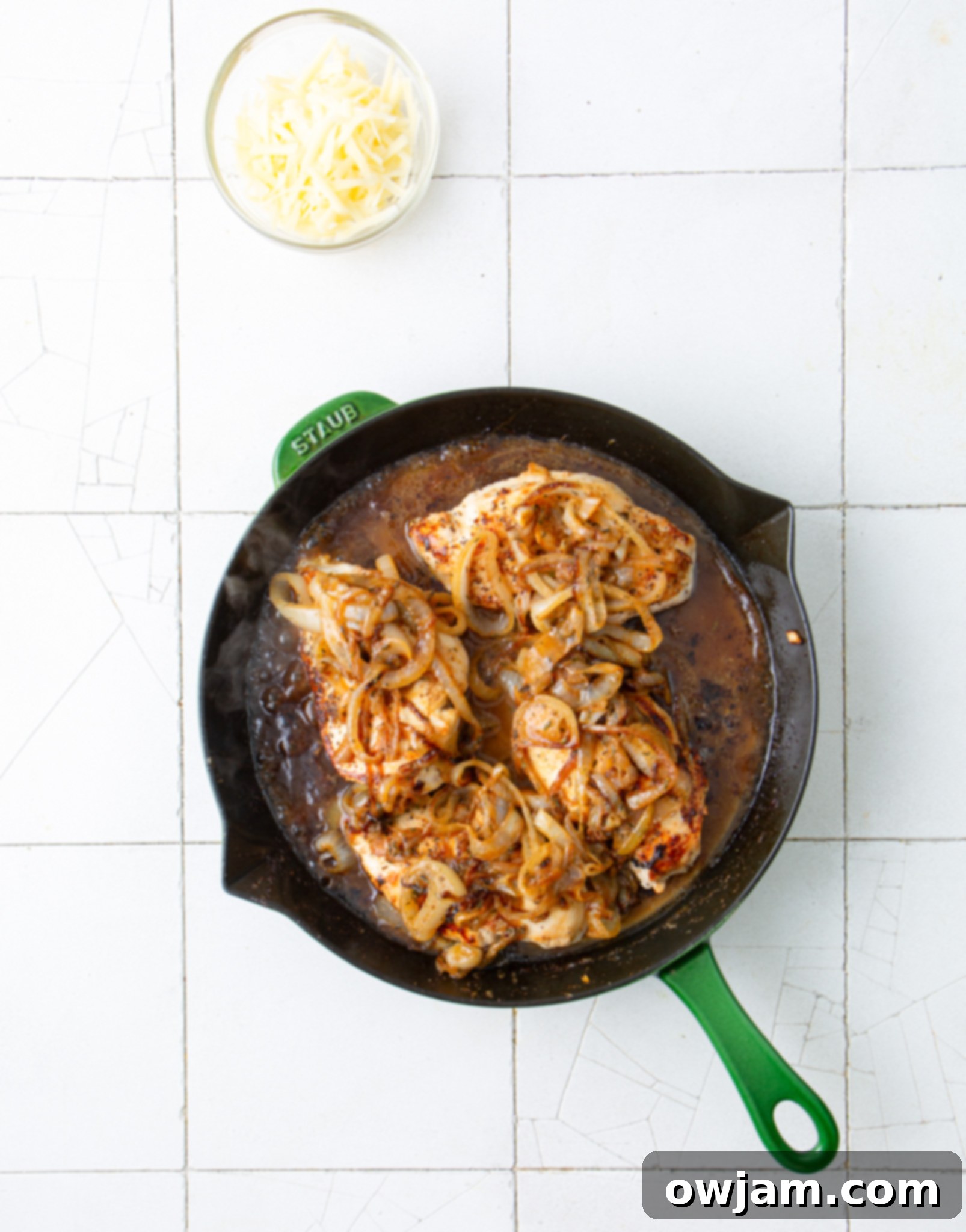 Irresistible French Onion Chicken 8 Sauce ingredients for French Onion Chicken being added to a skillet with chicken.