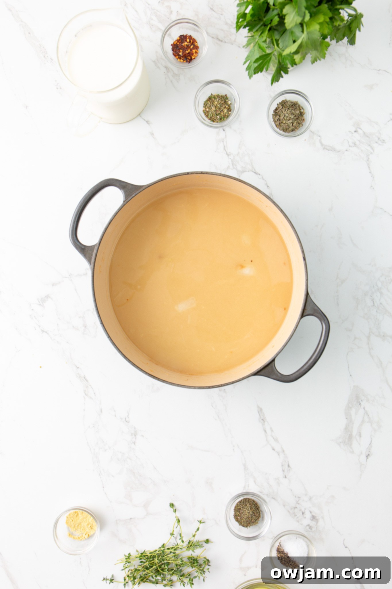 Make Olive Garden Chicken Gnocchi Soup at Home 7 Copycat Olive Garden Chicken Gnocchi Soup Recipe broth being added to the pot.