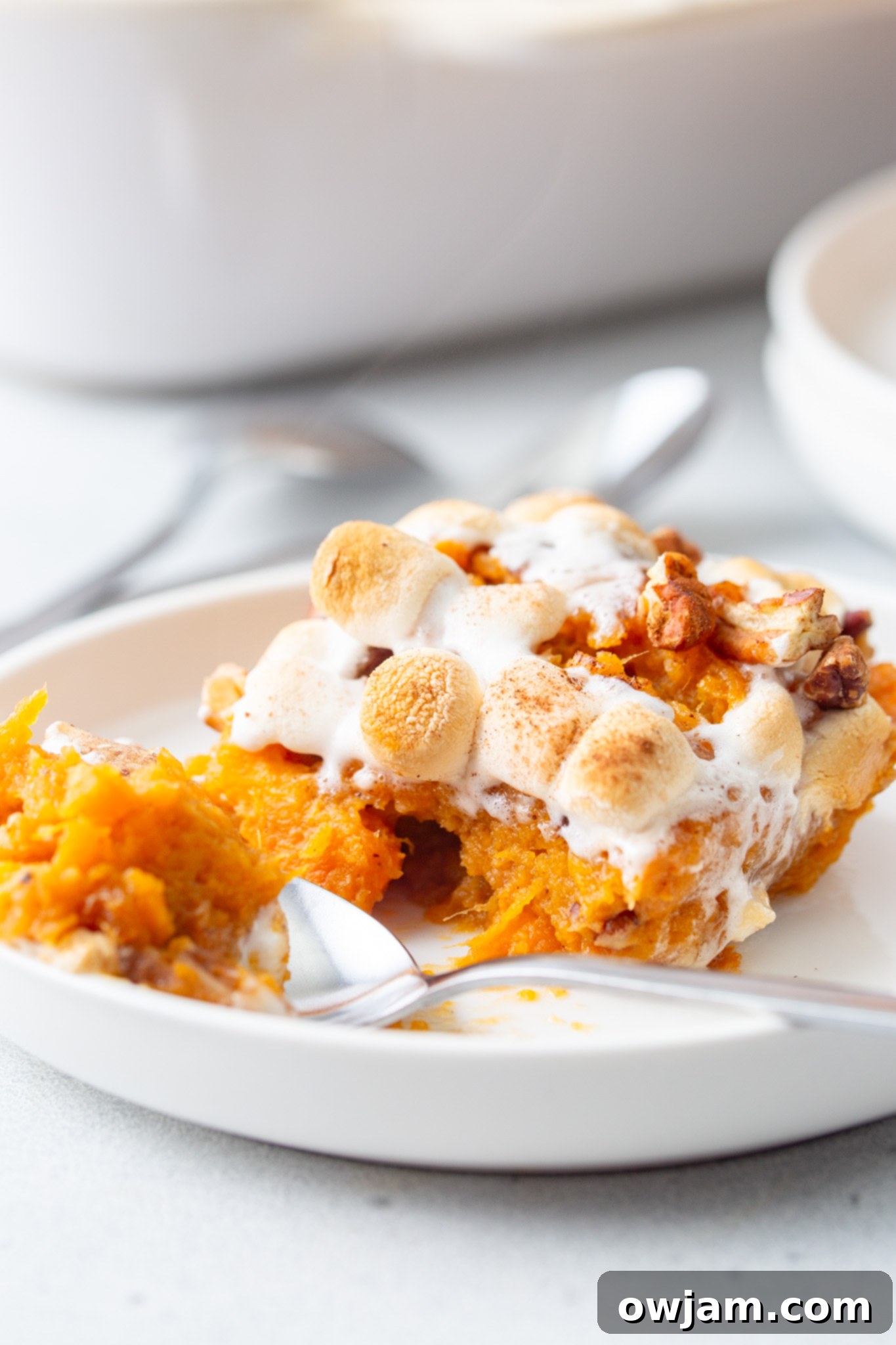 Golden Sweet Potato Marshmallow Bake 3 Sweet Potato Casserole with Marshmallows with a spoon