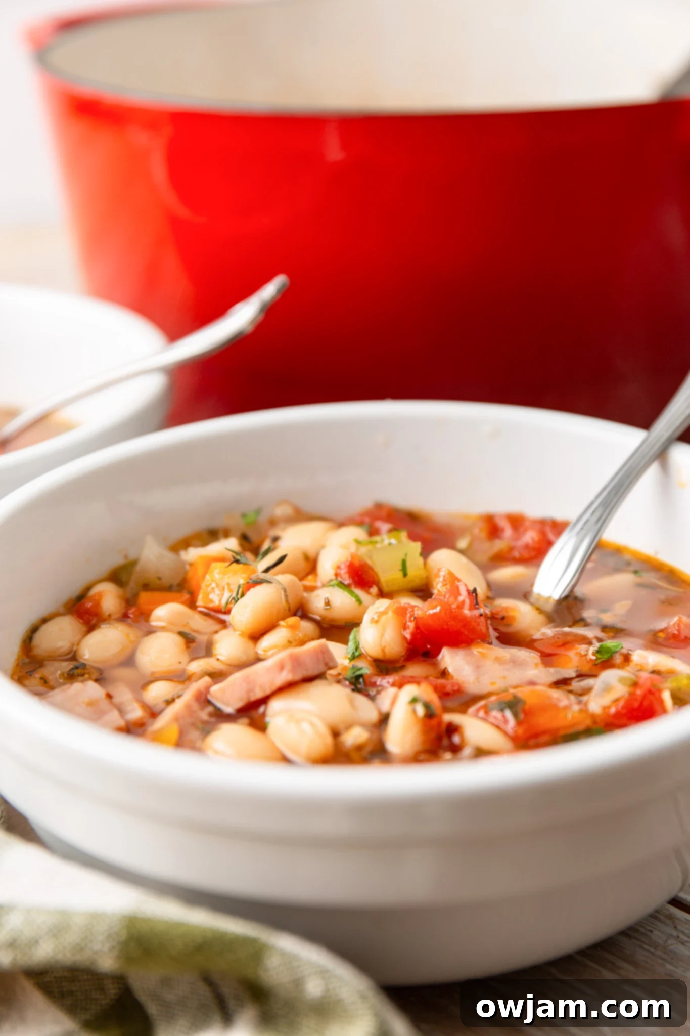 Navy Bean Soup Recipe simmering in a Dutch oven