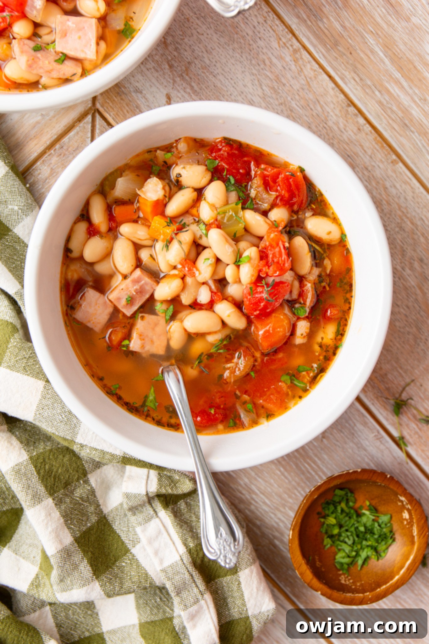 Navy Bean Soup Recipe served in a white bowl with a spoon
