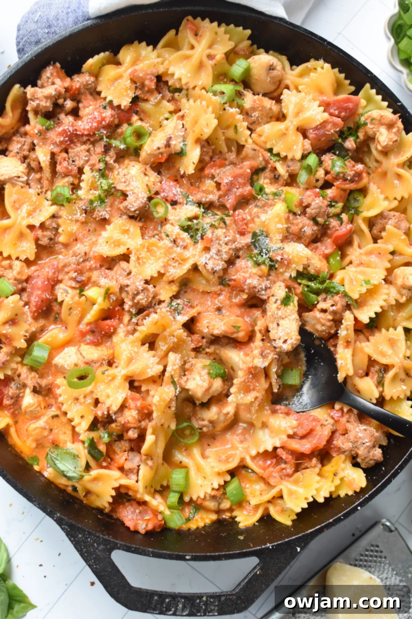 Creamy Chicken and Chorizo Pasta Recipe with black spoon.