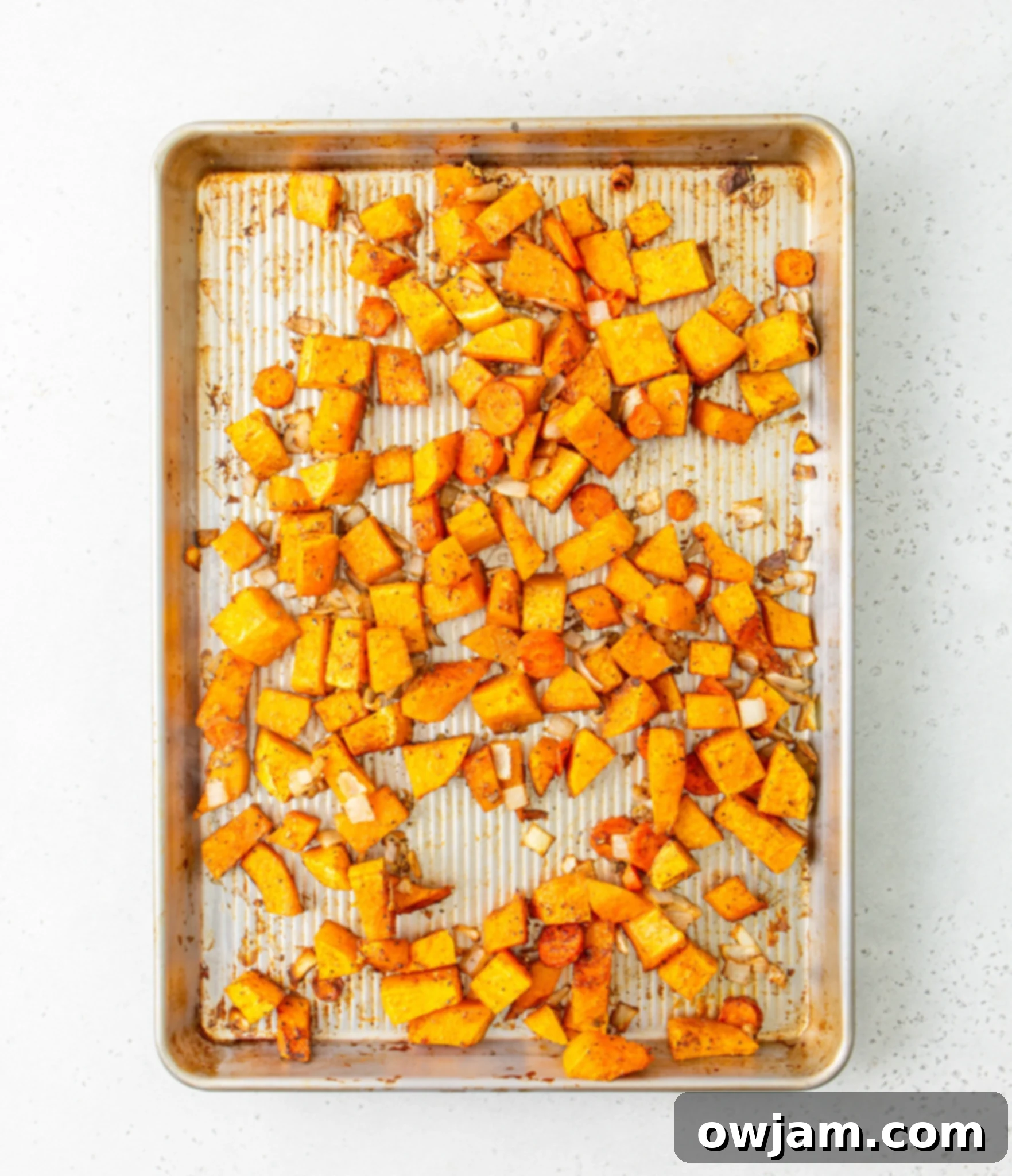 Cozy Roasted Butternut Squash Soup 7 Easy Roasted Butternut Squash Soup vegetables roasting on a sheet pan.