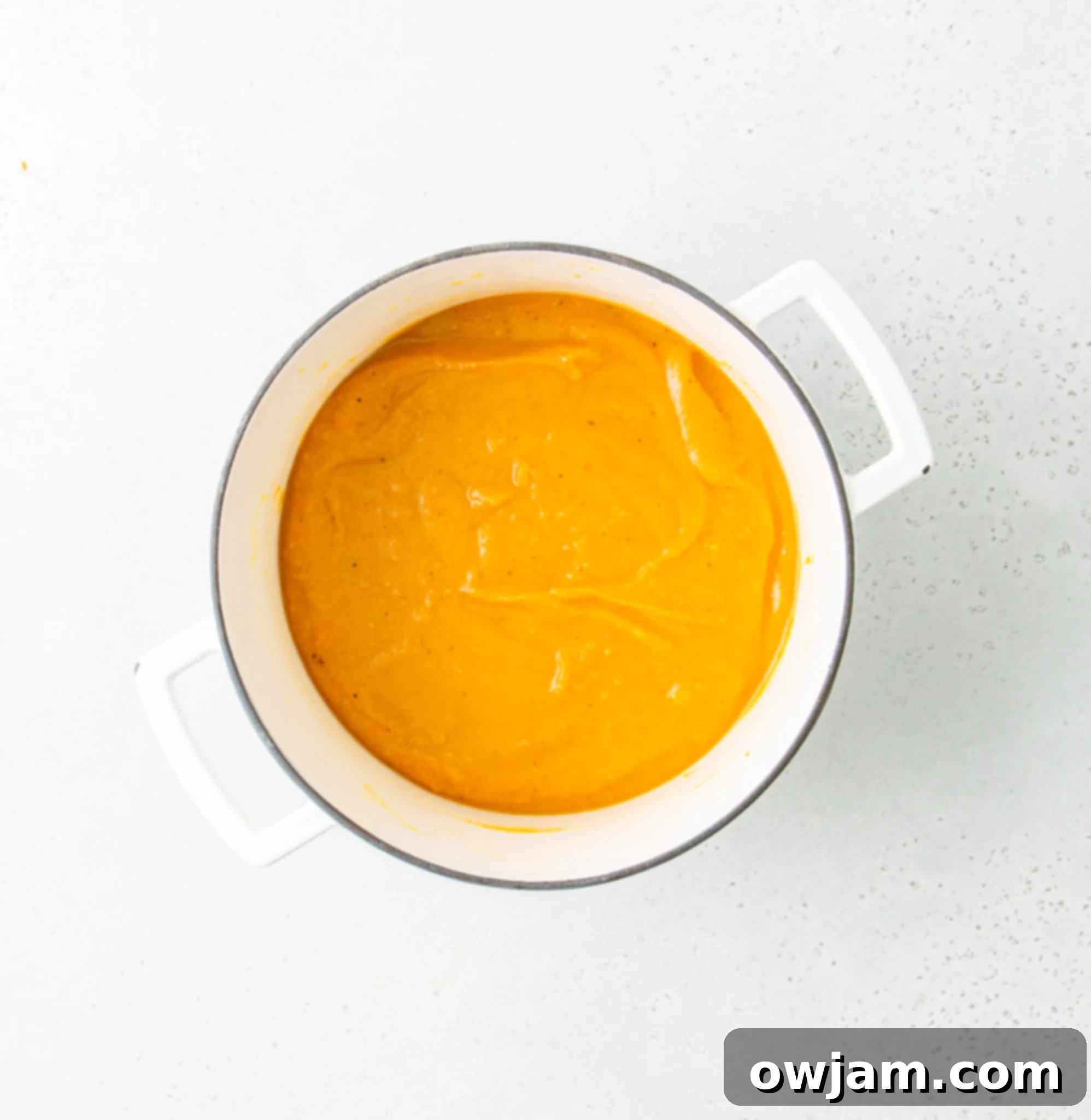 Cozy Roasted Butternut Squash Soup 8 Easy Roasted Butternut Squash Soup being blended in a Dutch oven.
