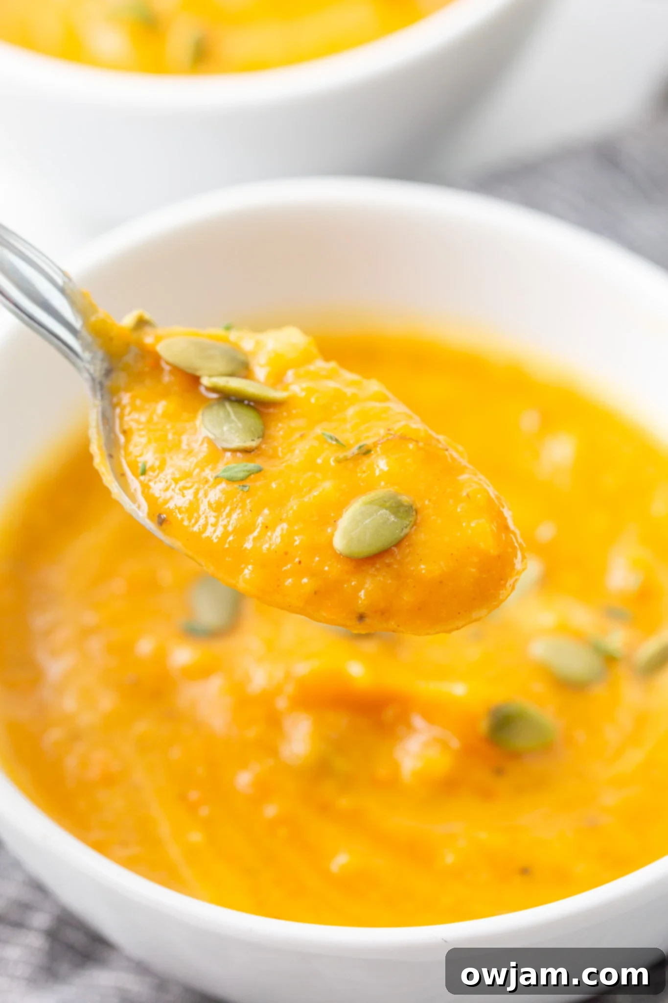 Cozy Roasted Butternut Squash Soup 10 Easy Roasted Butternut Squash Soup, showing its perfectly pureed, smooth texture on a spoon.
